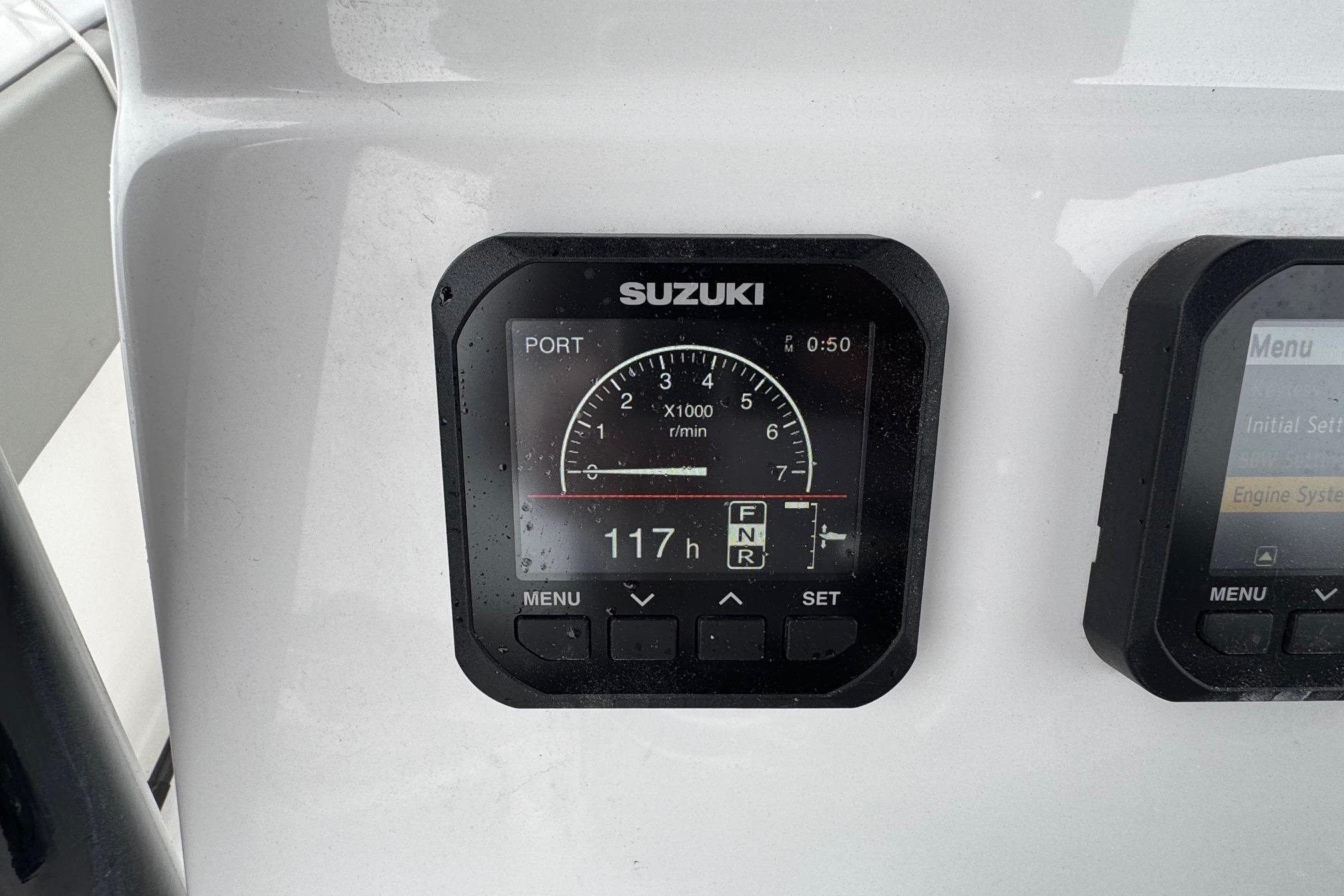 Suzuki engine display on 2024 Cape Horn 32 XS boat dashboard.