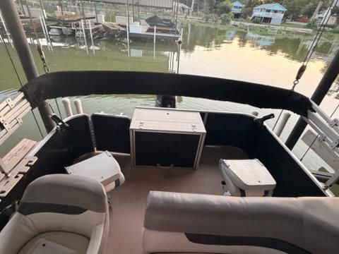 The image shows the cockpit of a 2013 Cypress Cay Seabreeze 212 pontoon boat docked.