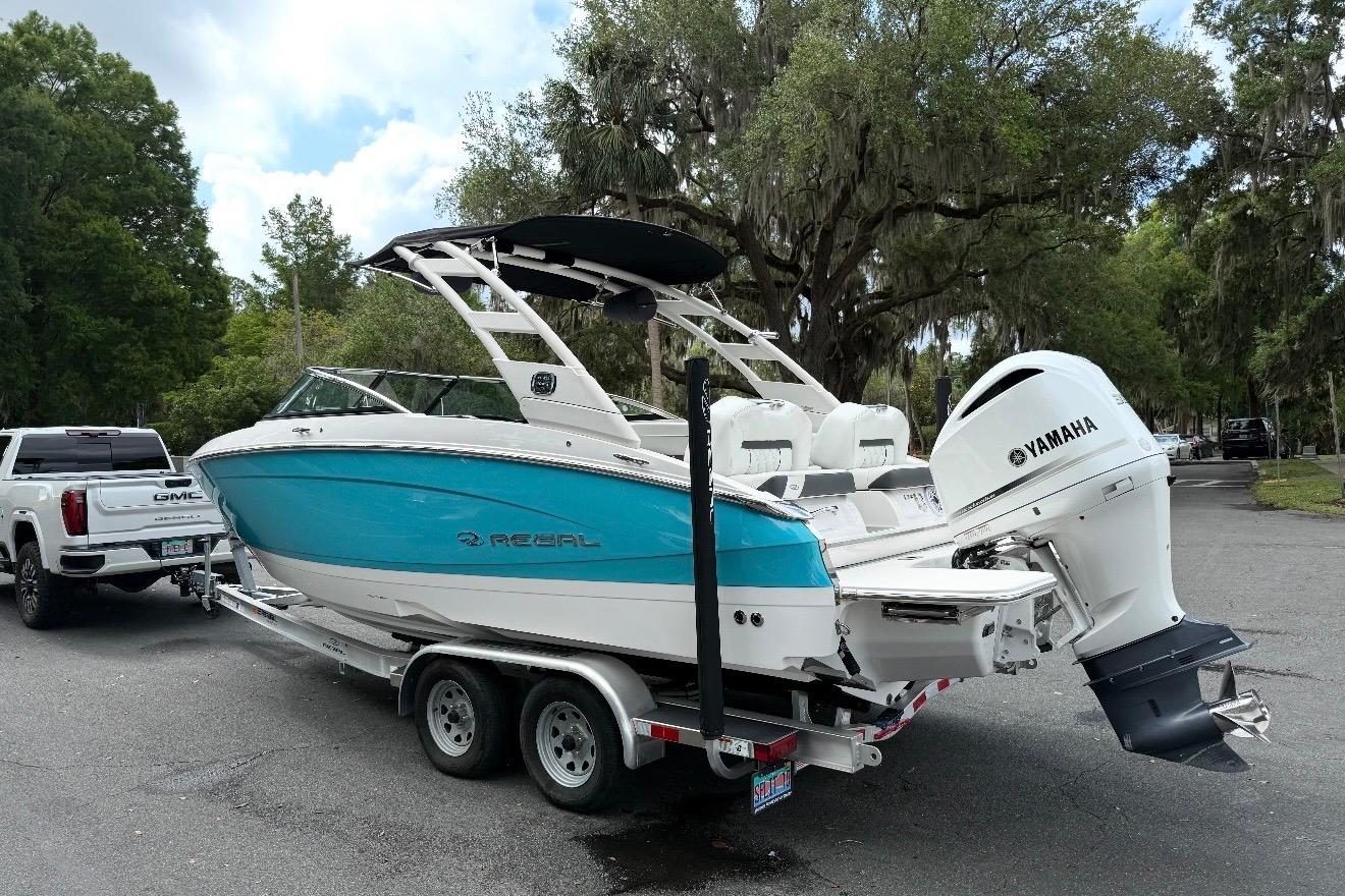 2020 Regal LX4 boat with Yamaha engine on trailer, towed by GMC vehicle.