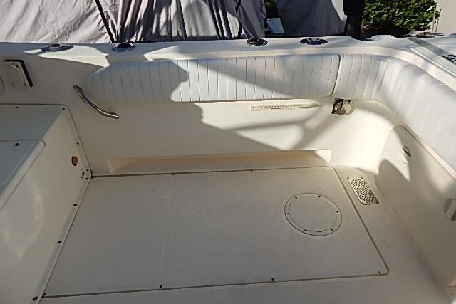 2003 World Cat 270 EC boat interior with white seating and deck area.