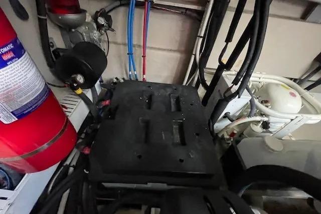 Engine room of 2016 Sea Ray Sundancer 510 with fire extinguisher and wiring.