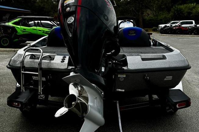 2026 Ranger Z185 boat with powerful outboard motor, parked in a lot.
