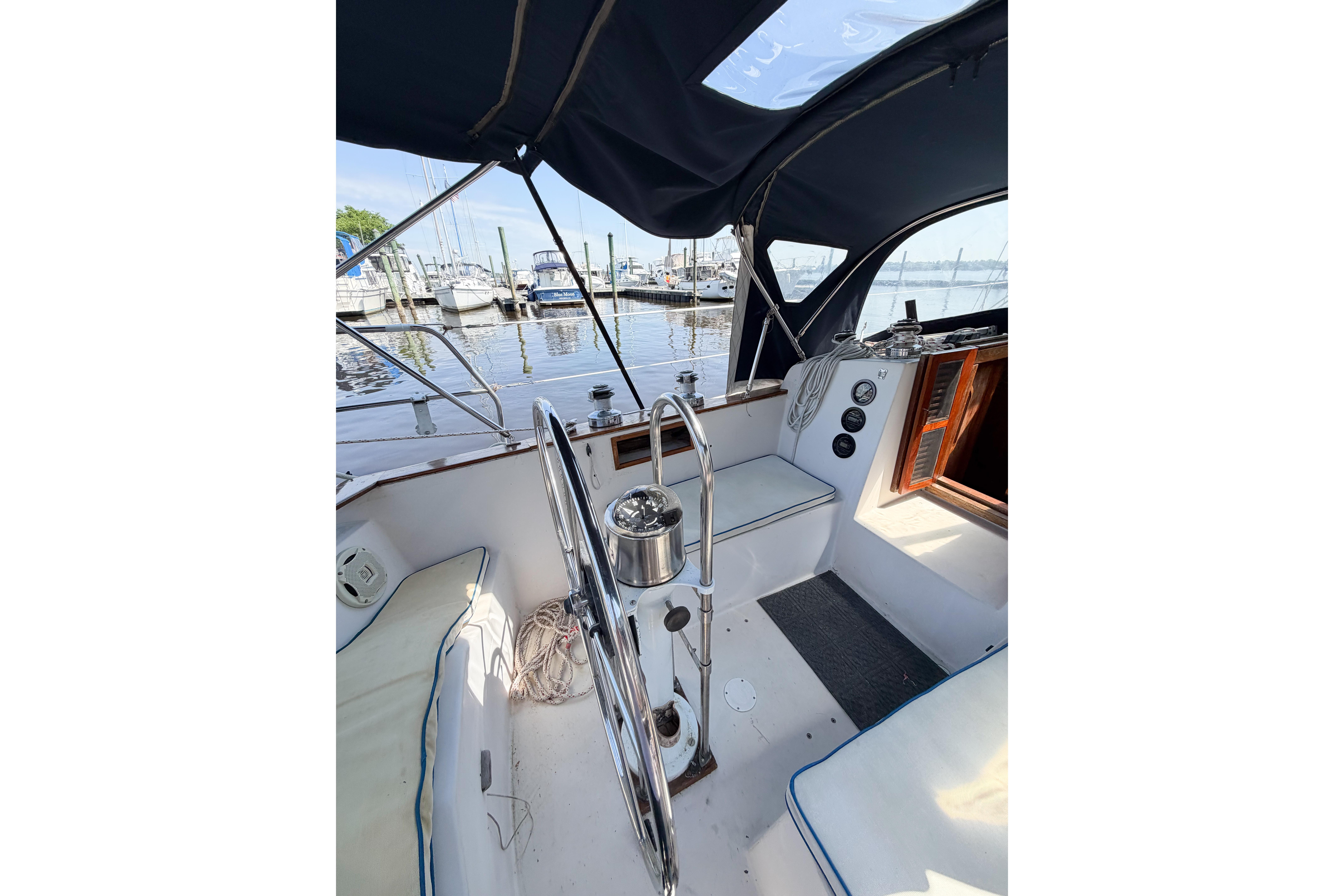 Cockpit of a 1987 Bayfield 36 sailboat with marina view.