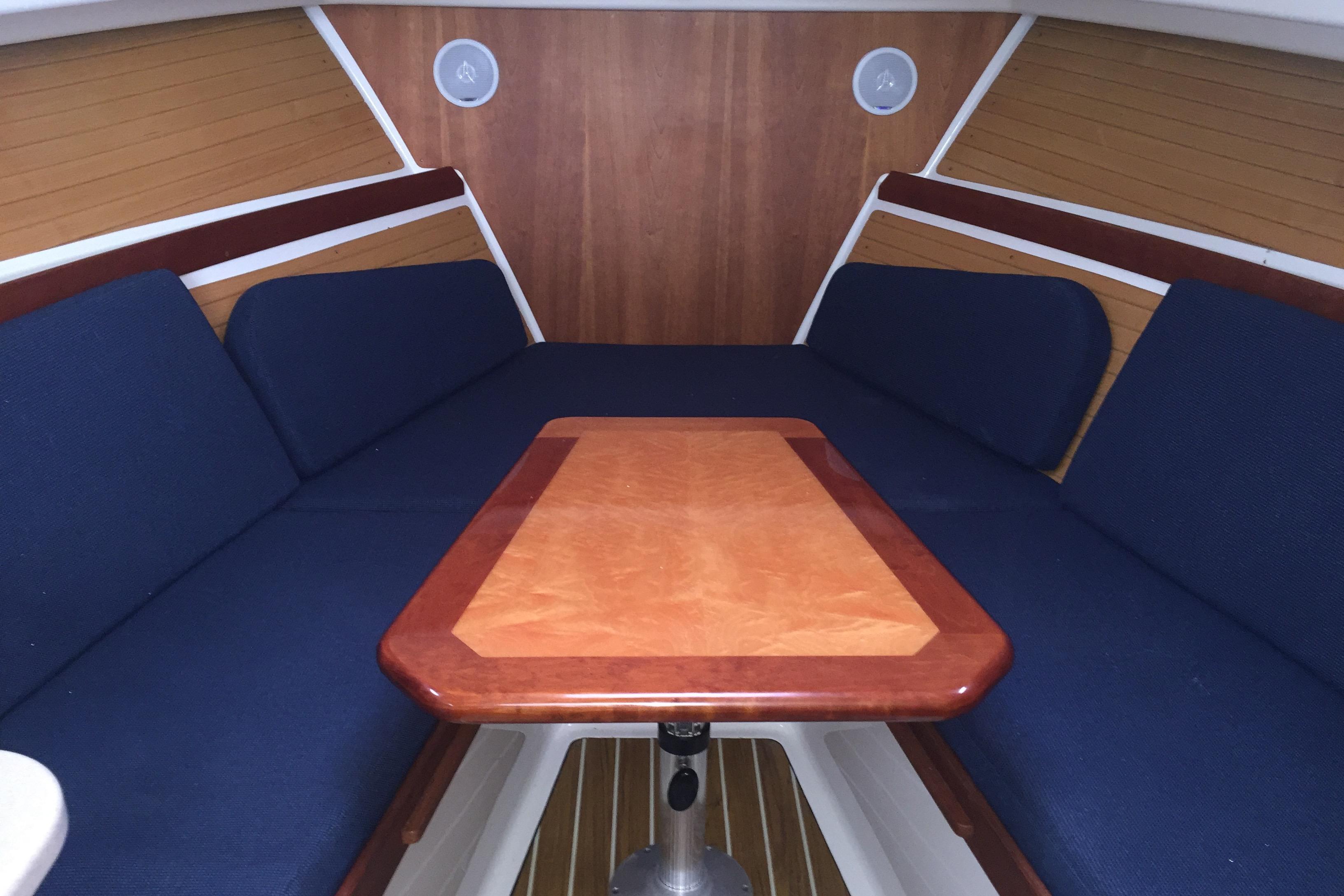 2007 Back Cove 29 interior with blue seating and wooden table.