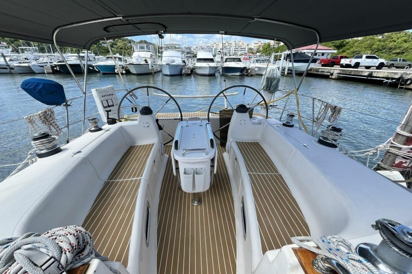 Cockpit view of a 2003 Bavaria 44 sailboat docked at a marina.