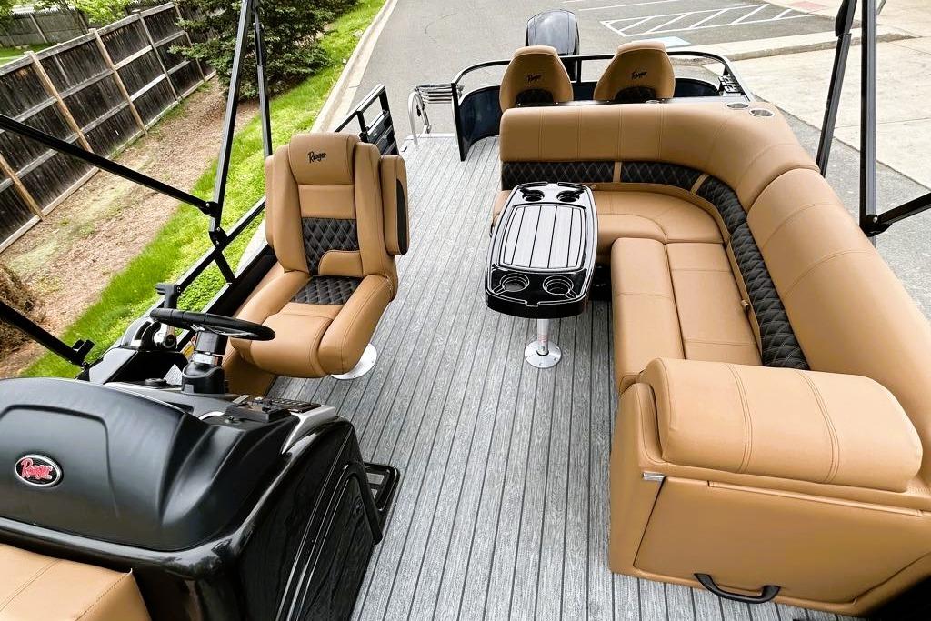 Luxurious interior of 2026 Ranger 220FC boat with tan seating and sleek design.