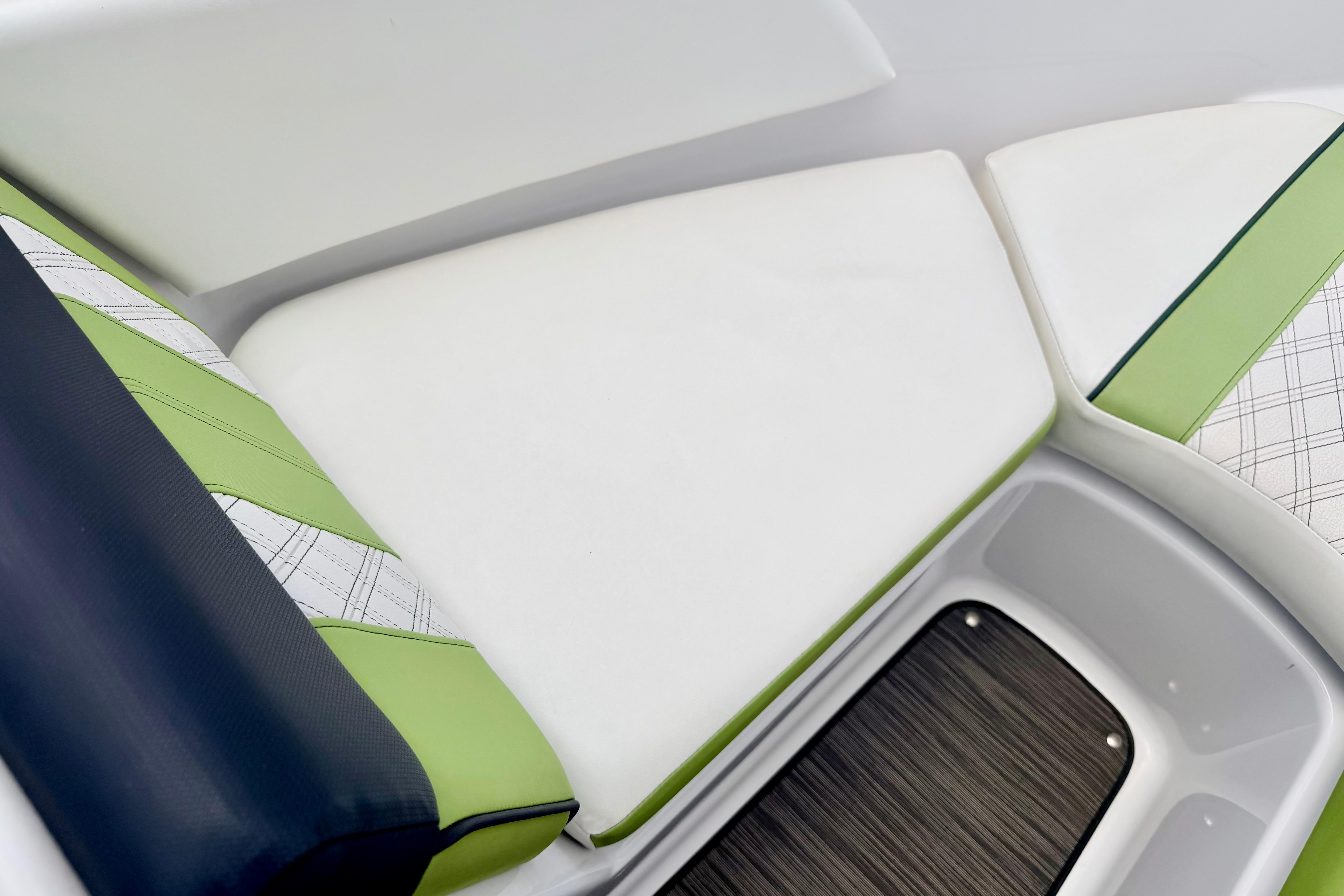 2018 Glastron GT 185 boat interior with stylish green and white seating.