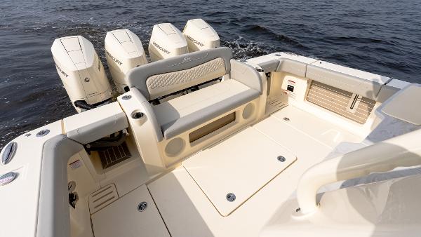 2025 Scout 425 LXF boat interior with seating and multiple outboard engines on water.