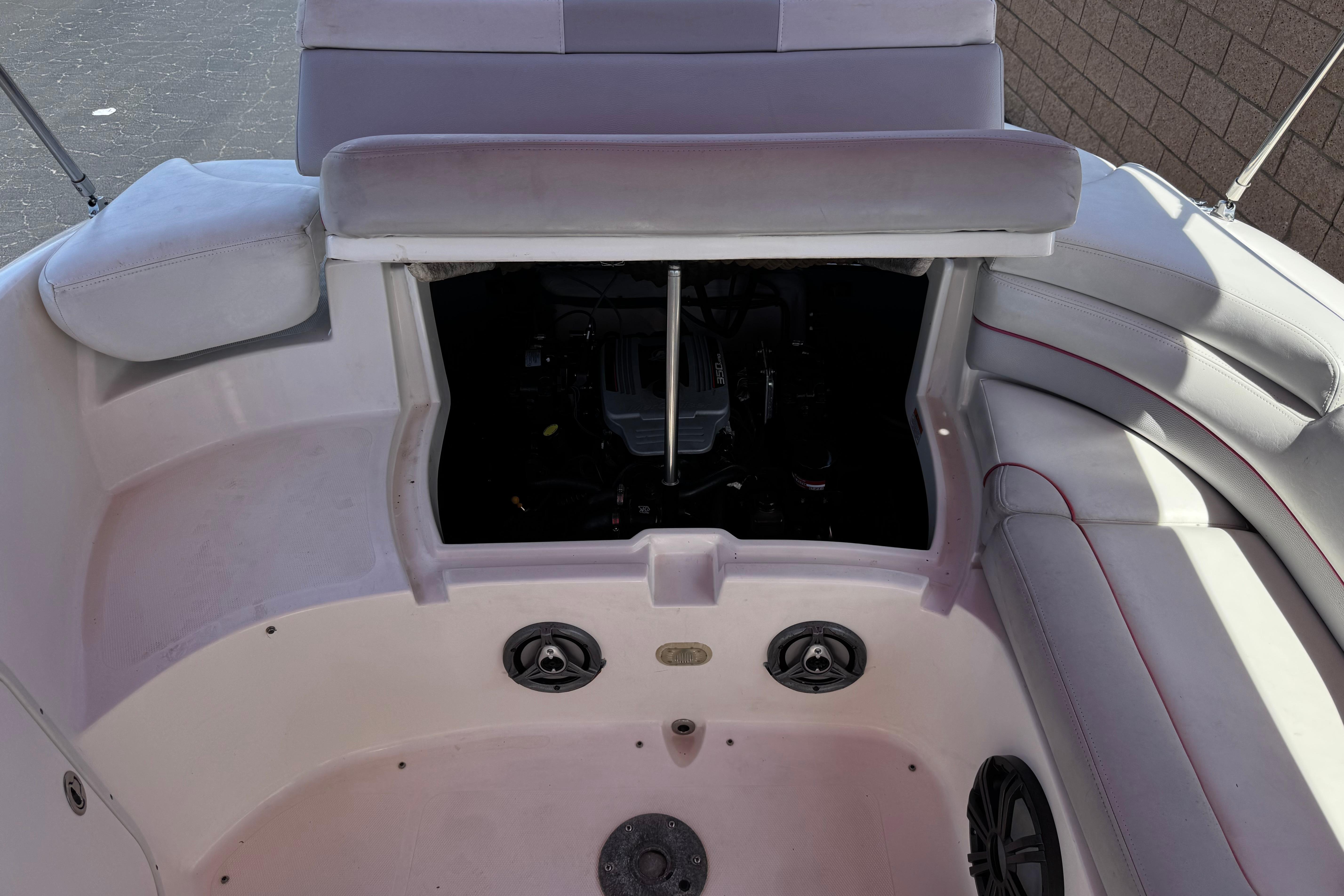 2010 Bryant 255 boat interior with open engine compartment and seating area.
