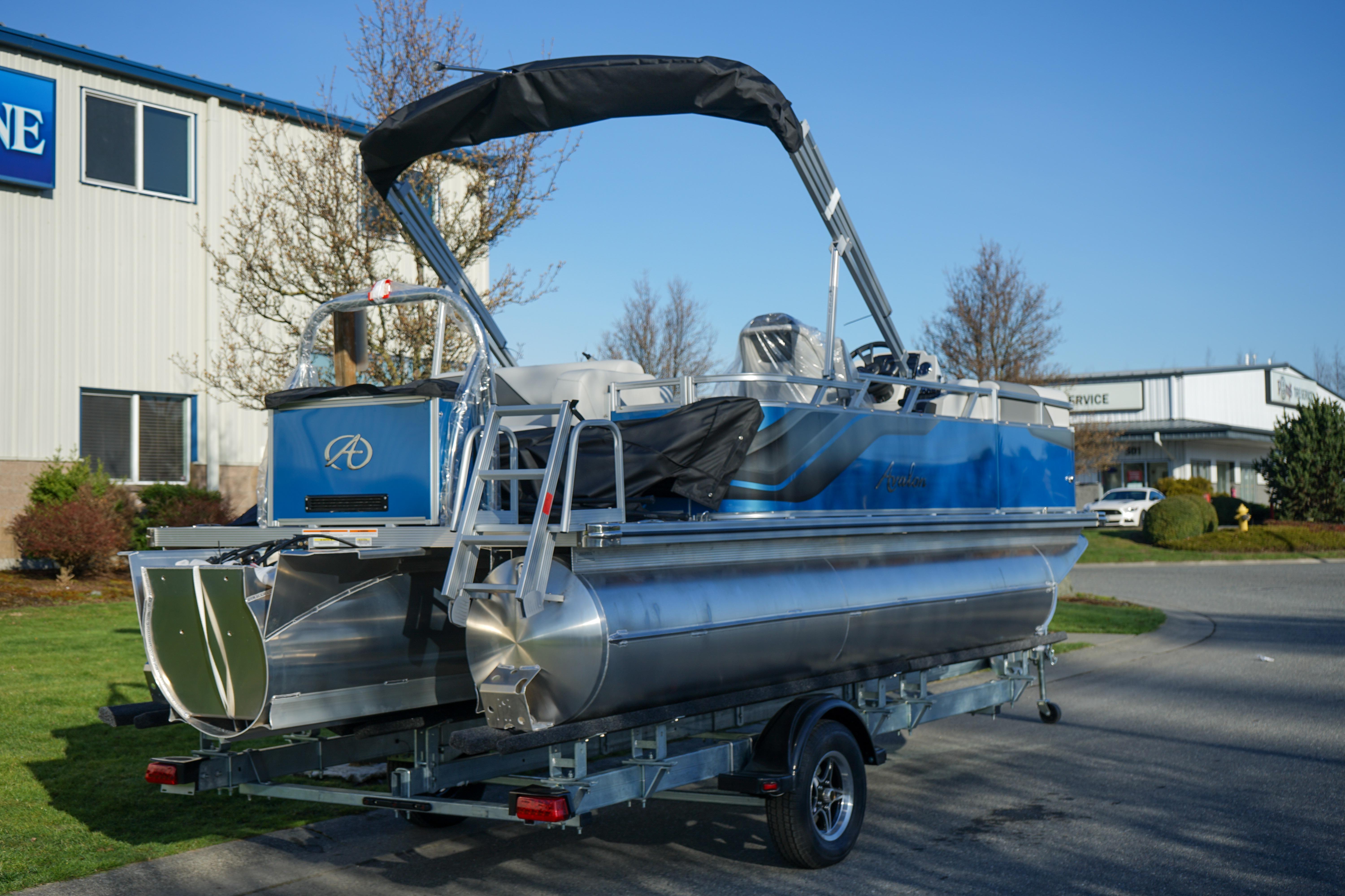 2024 Avalon 17 Venture Cruise pontoon boat on trailer, parked outdoors.