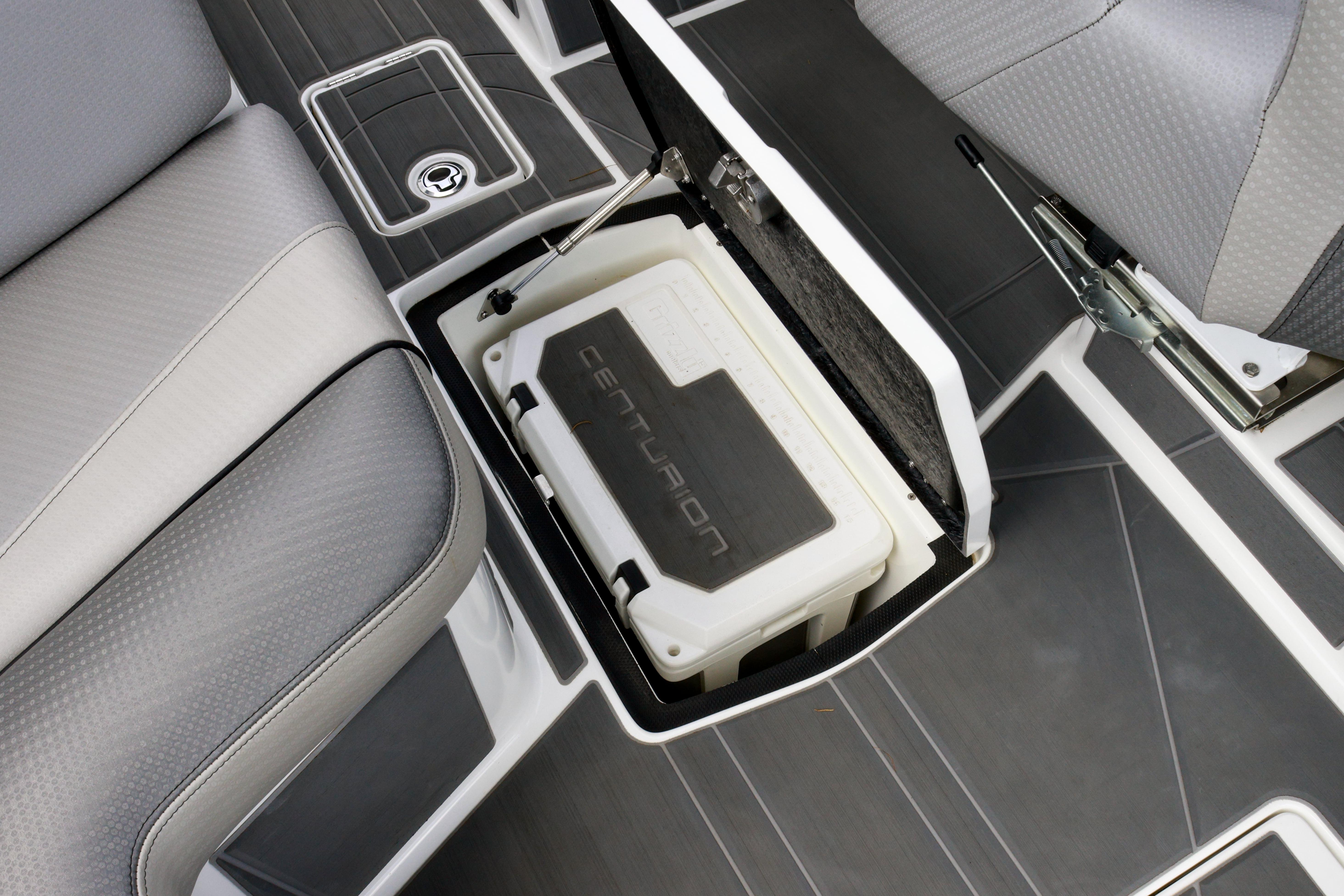 2022 Centurion Ri245 boat interior with storage compartment and cooler.