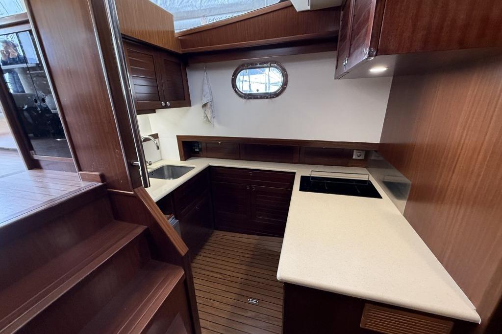 Luxurious 2012 Sasga Yachts Menorquin 42 kitchen with wood cabinetry and modern appliances.
