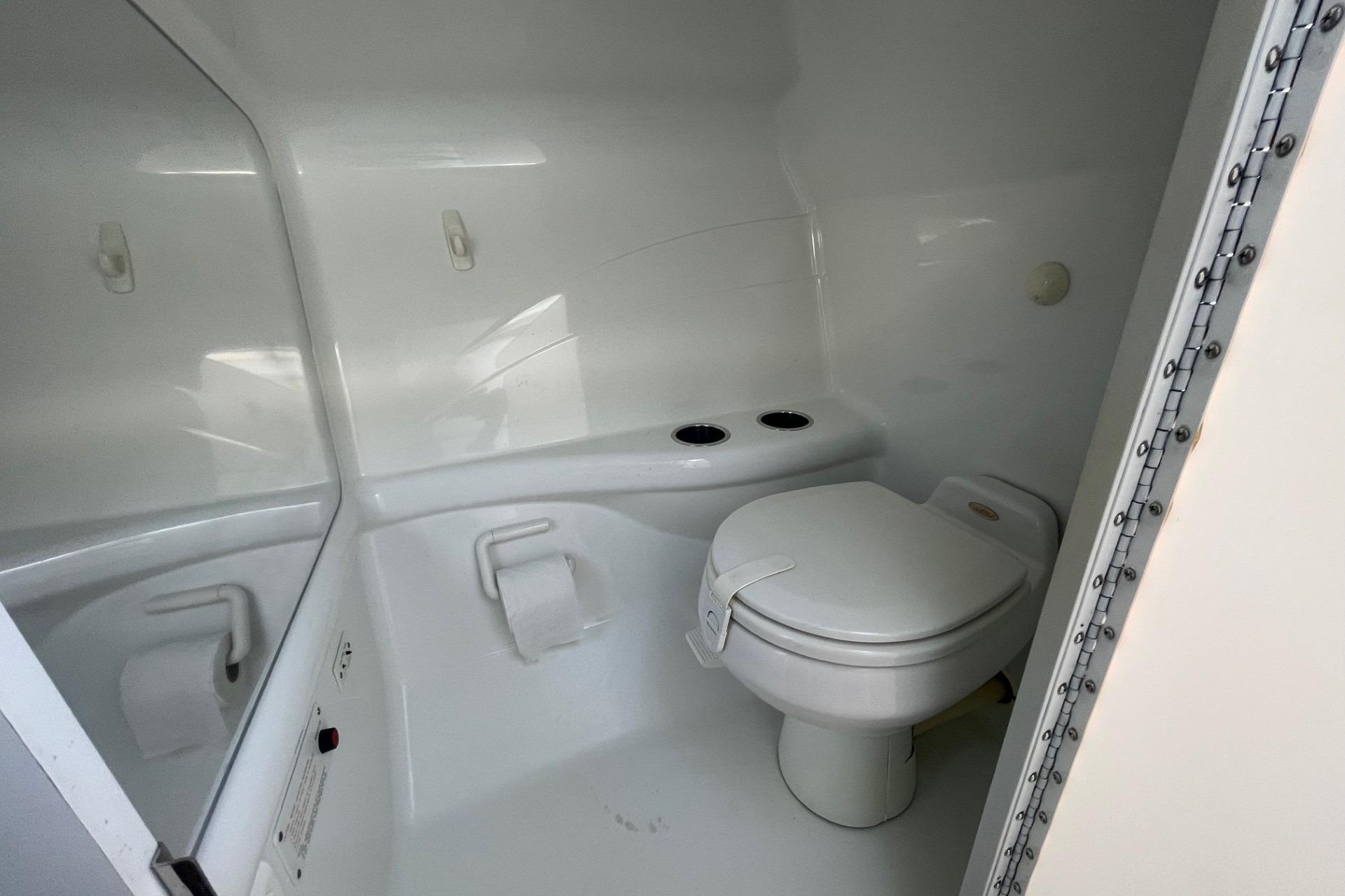 2004 Formula 382 FASTech boat bathroom with white toilet and sleek design.
