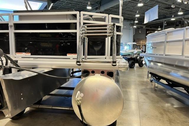 2026 Sun Tracker SportFish 20 DLX pontoon boat displayed in a showroom.