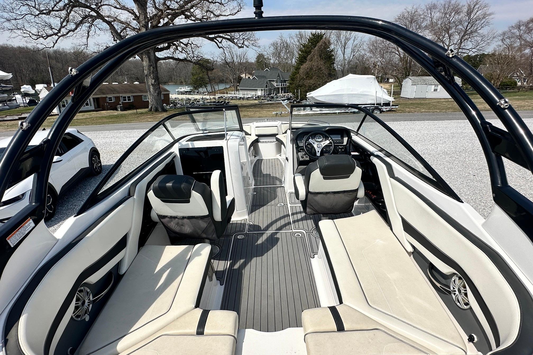 2016 Yamaha 242 Limited S boat interior with seating and steering wheel, parked outdoors.
