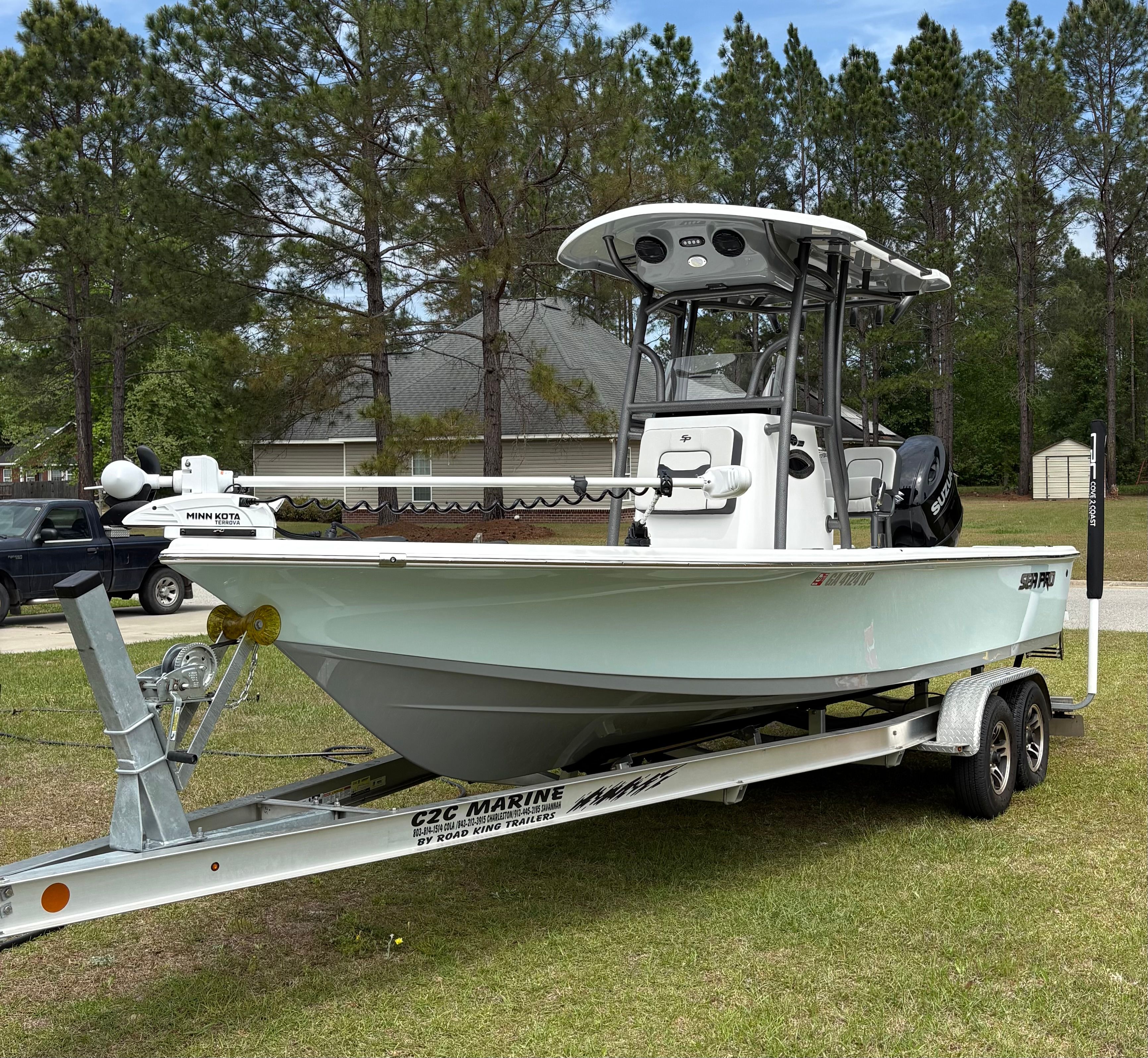 2025 Sea Pro 230 Bay boat on trailer outdoors.