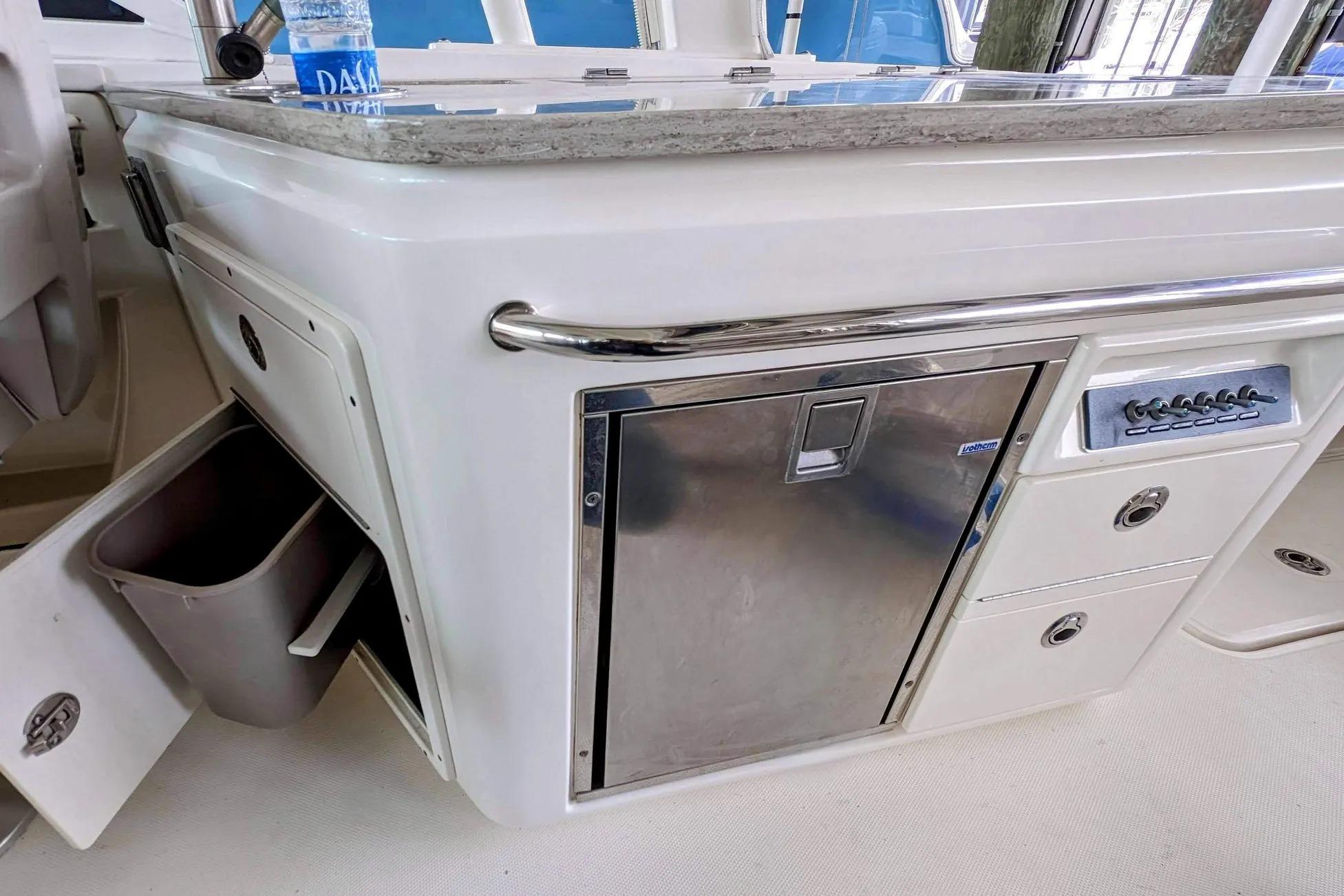 Interior view of a 2017 Boston Whaler 320 Vantage boat with storage and control panel.