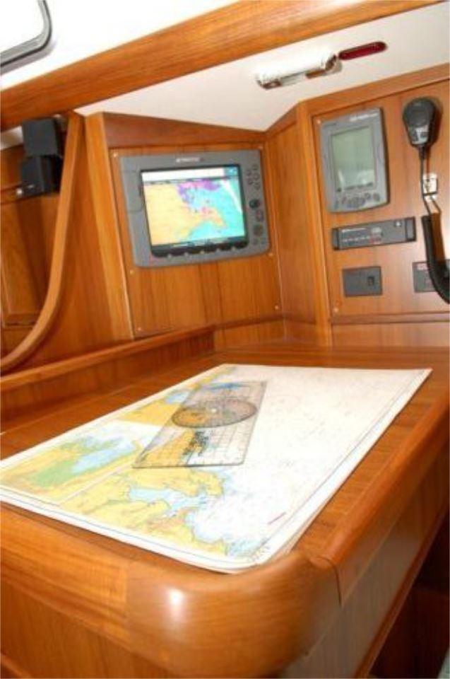 Navigation station on 2025 Rustler 42 yacht with map and electronic display.