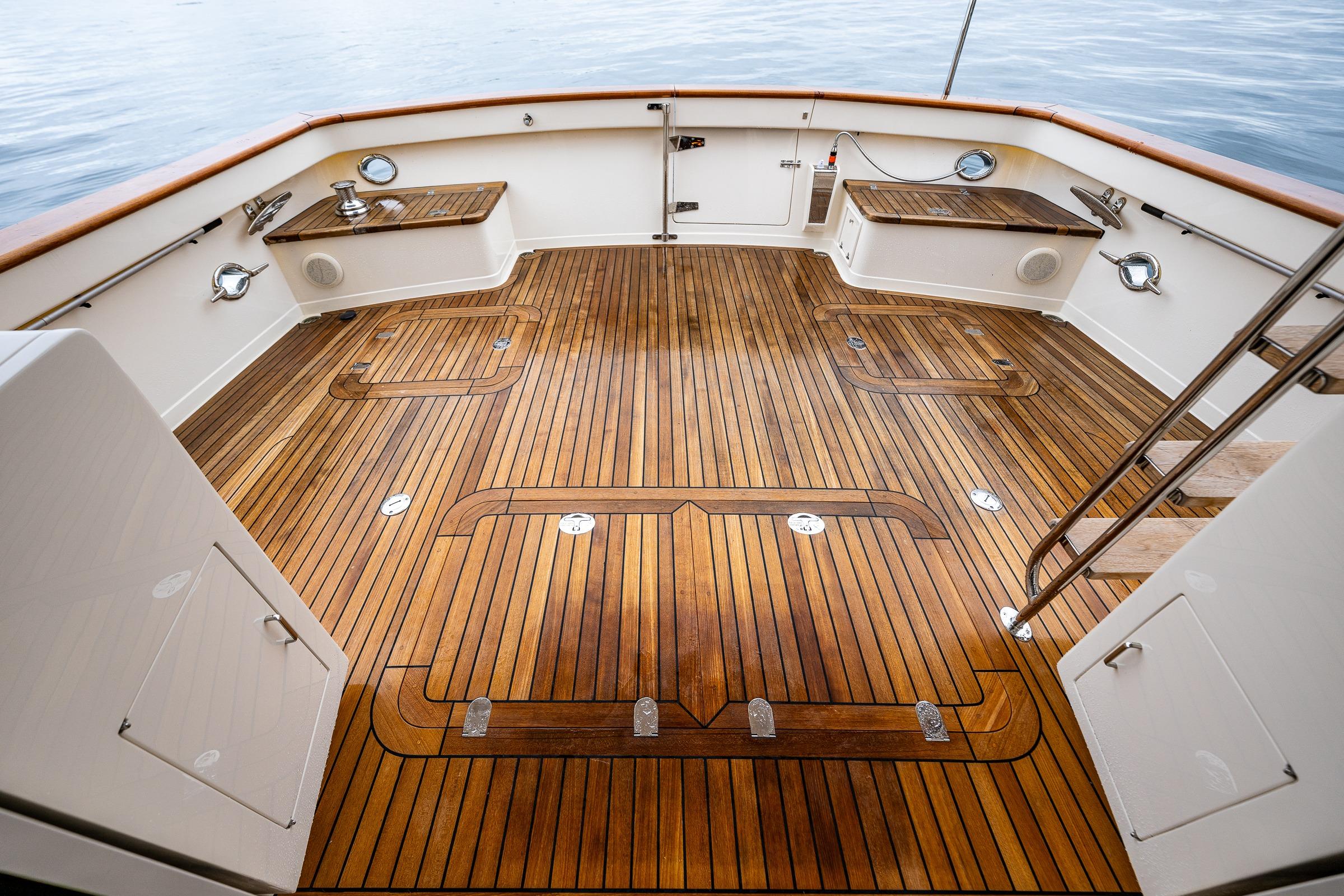 Luxurious 2026 Fleming 55 Pilothouse yacht deck with polished wood finish.