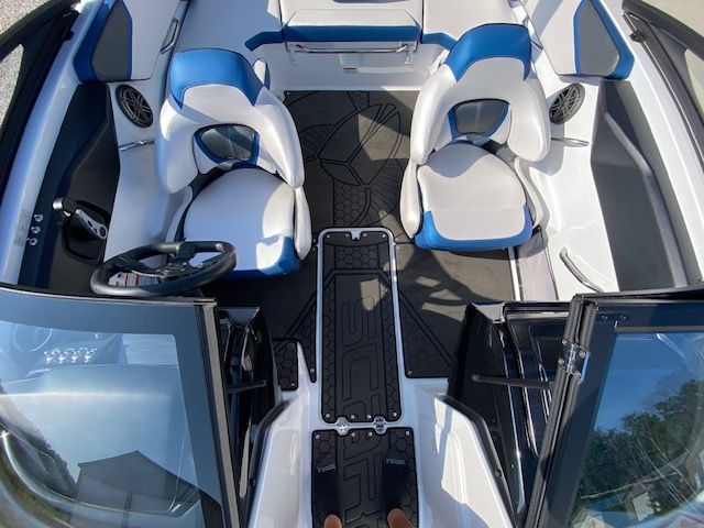 Interior of a 2024 Scarab 195 ID with white and blue seats and modern design.