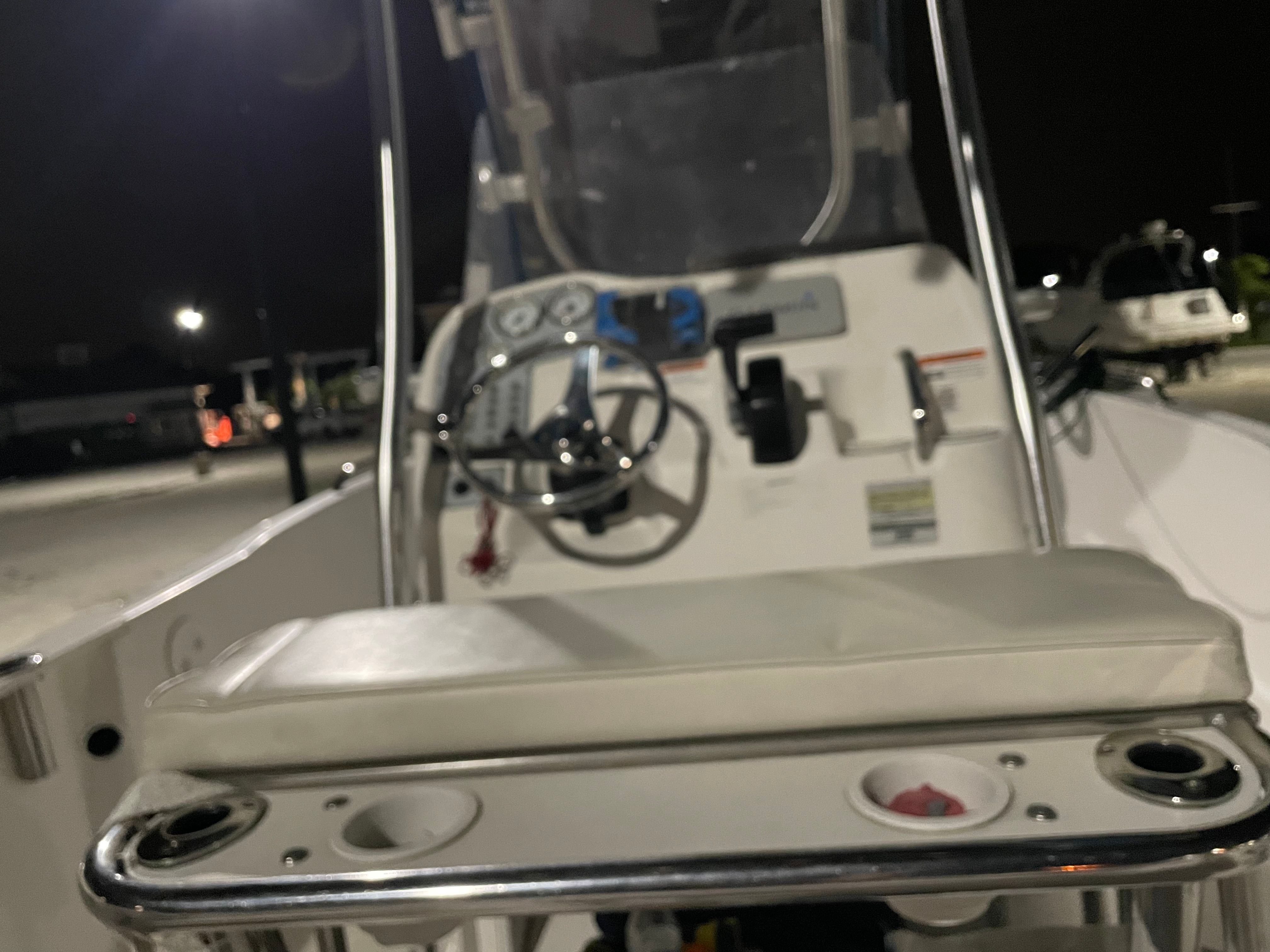 Interior view of a 2005 Aquasport 210 Osprey boat at night.