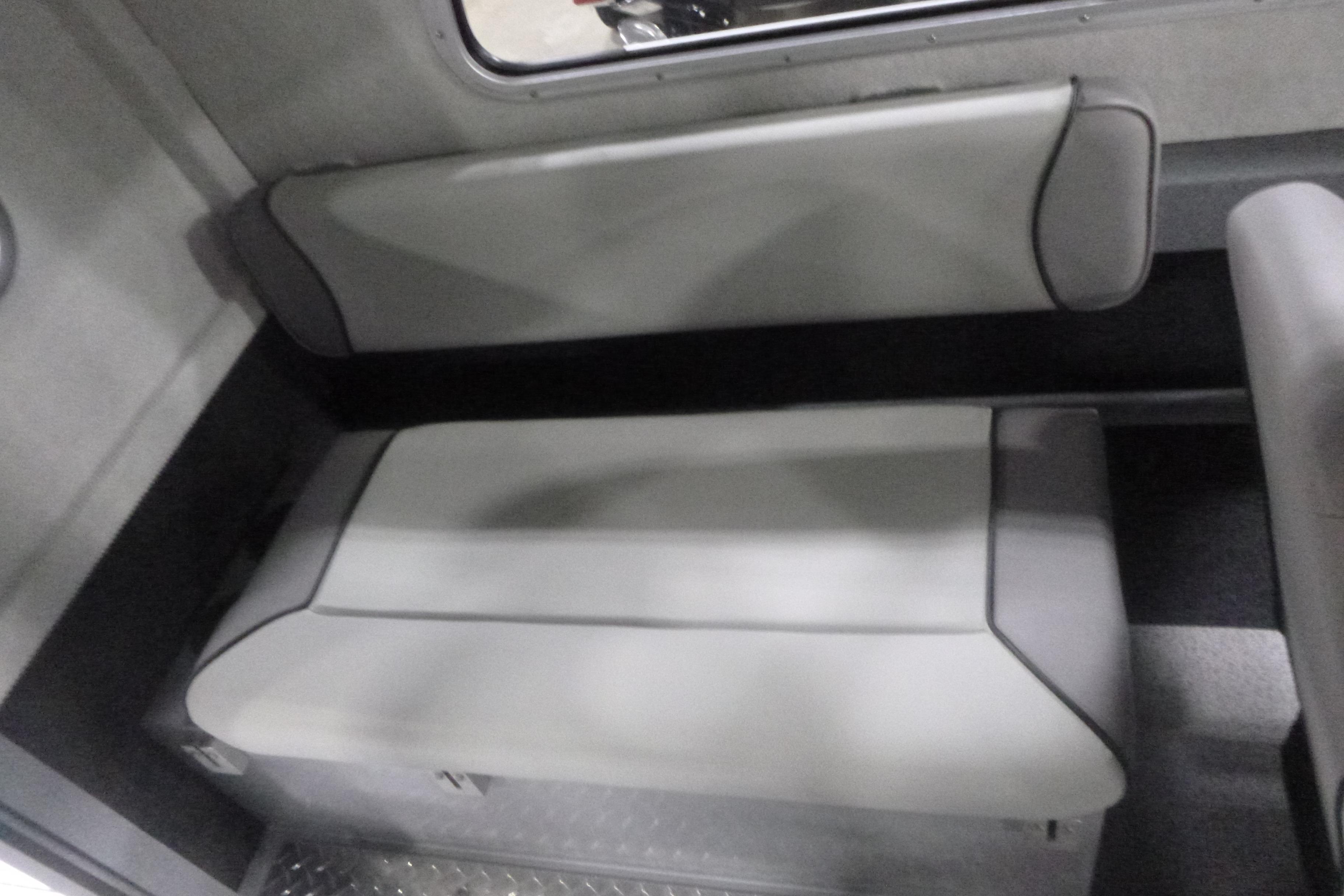 Interior seating of 2026 KingFisher 2425 Escape HT boat, featuring gray cushioned benches.