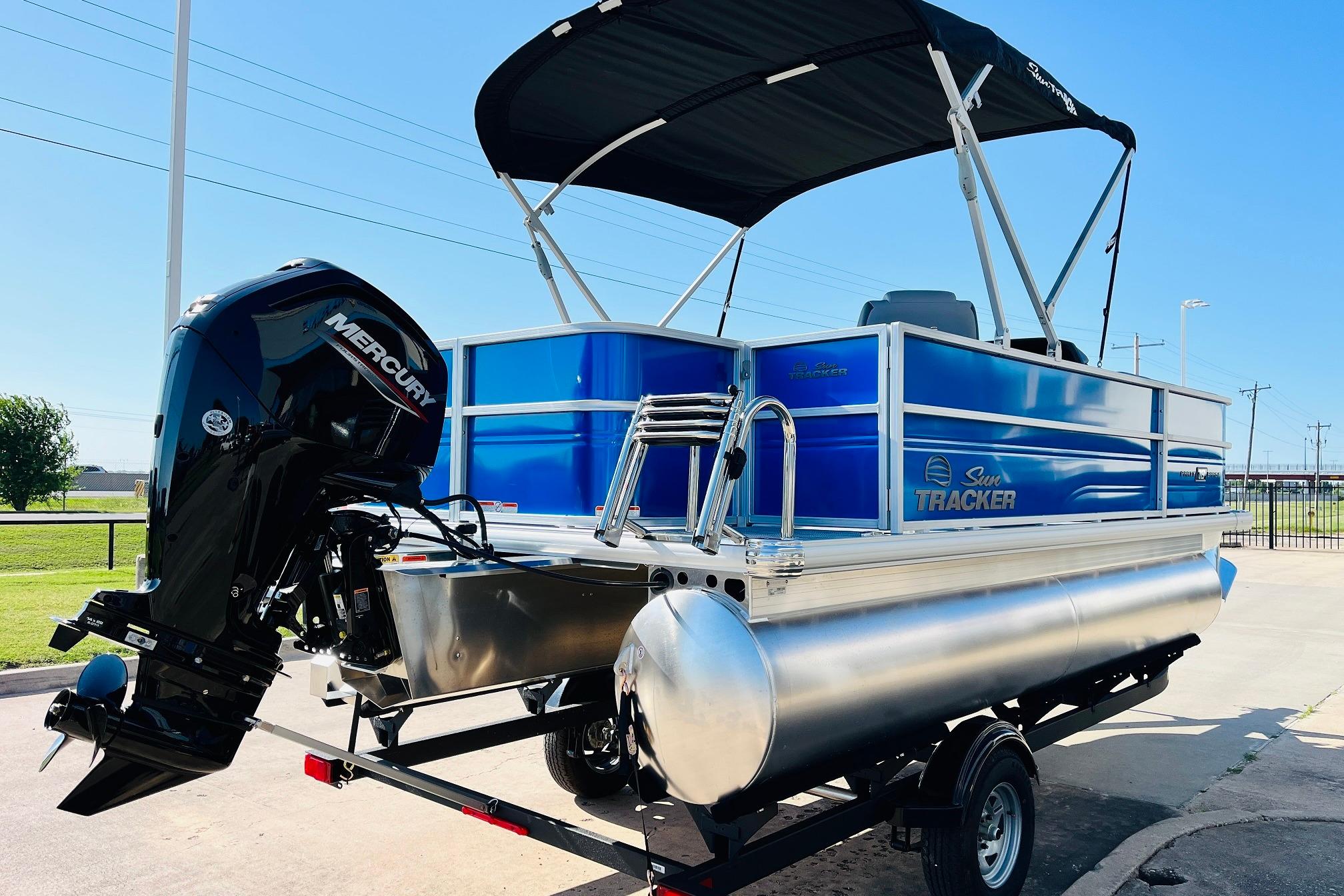 2026 Sun Tracker Party Barge 18 DLX pontoon boat with Mercury outboard motor.