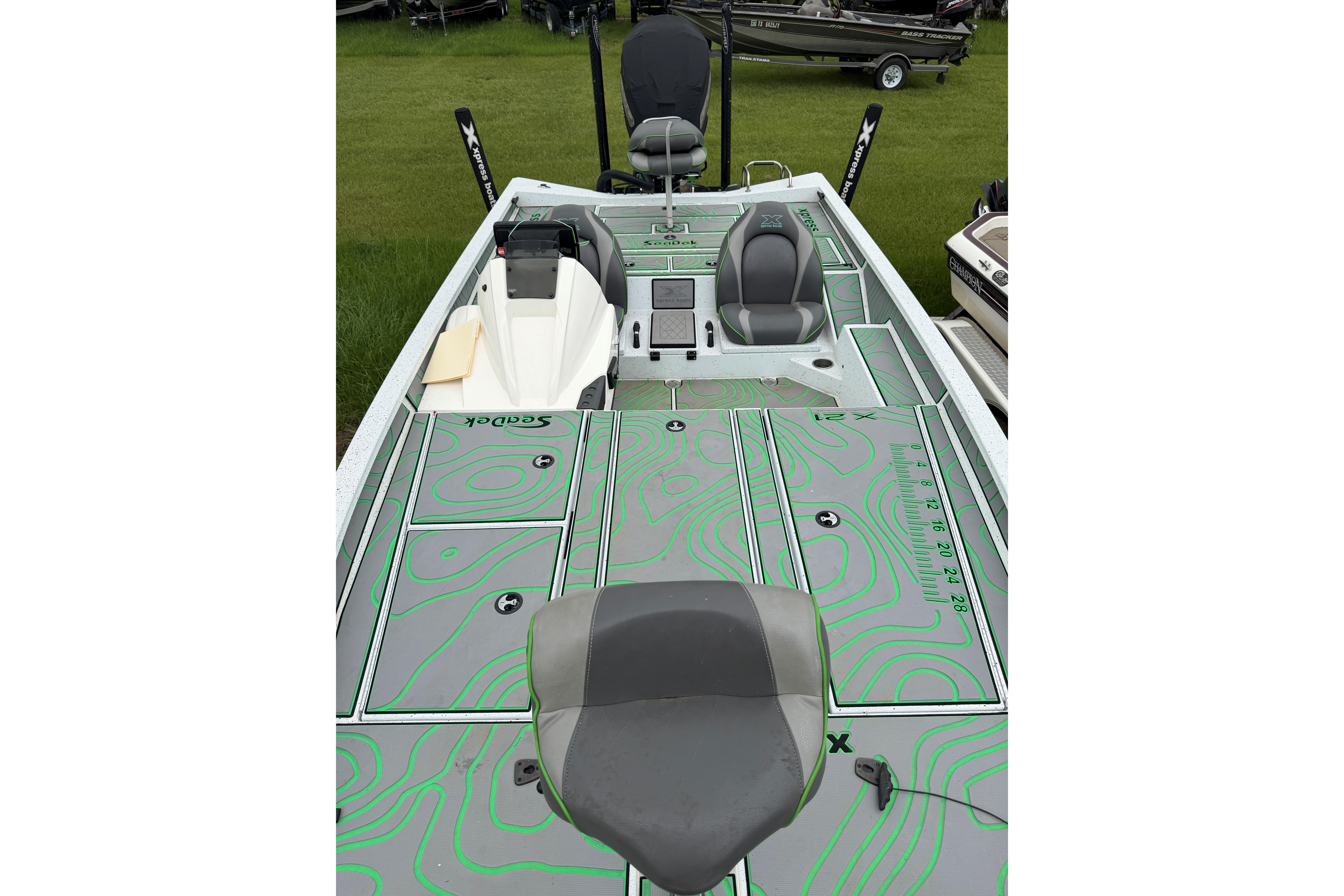 2022 Xpress X21 Pro boat interior with green patterned deck and seating.