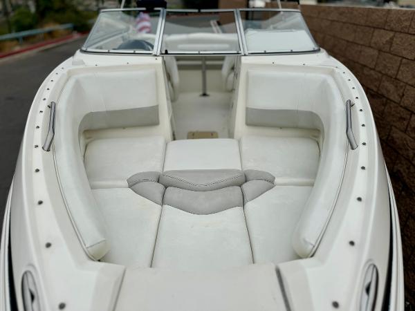 2006 Larson LXi 248 boat interior with white seating and windshield.