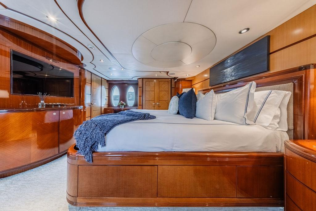 Luxurious bedroom interior of 2012 Ares Custom Marine Custom 141 yacht, featuring elegant wood finishes.