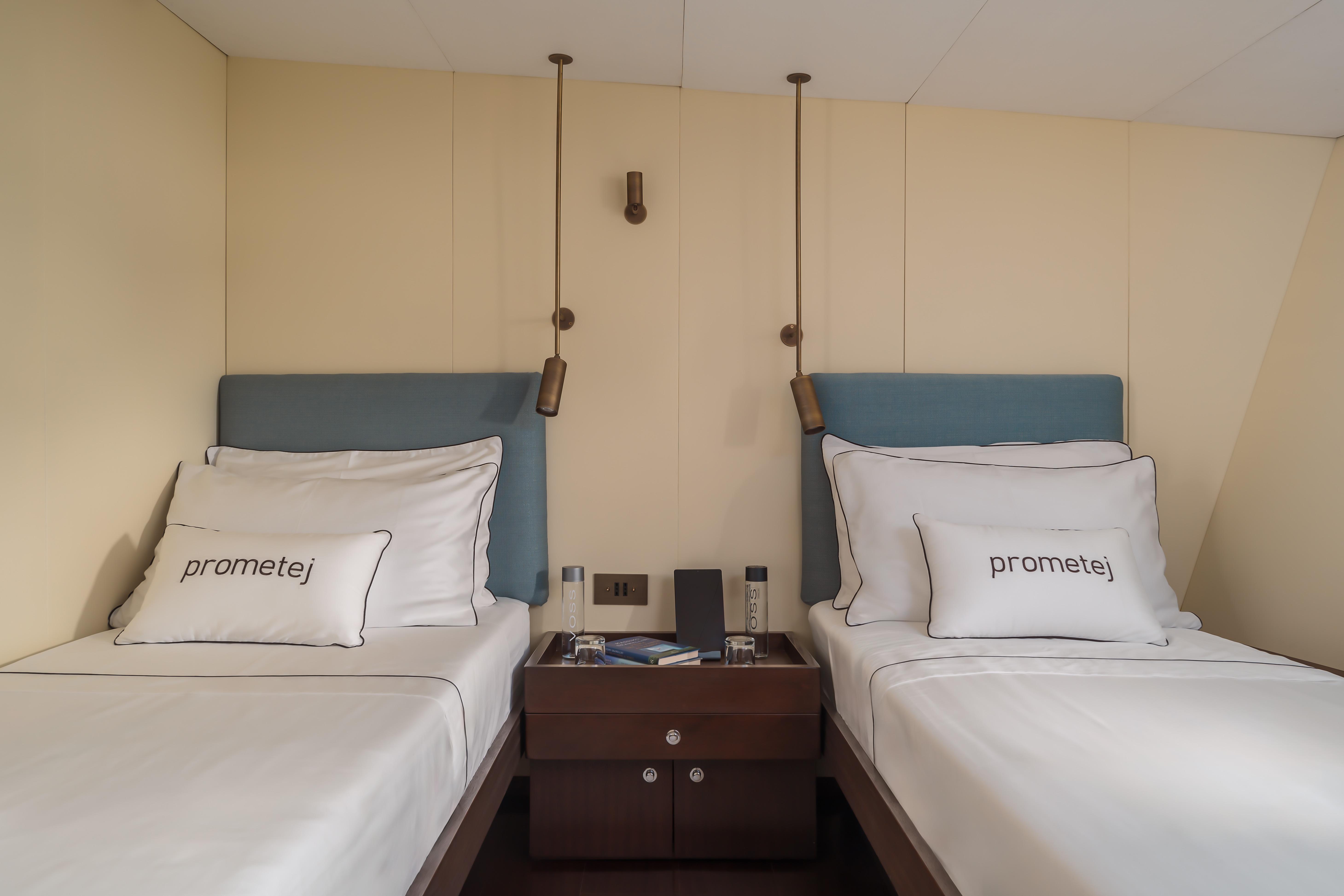 Twin beds in a 1956 custom converted tugboat cabin, featuring "prometej" pillows.