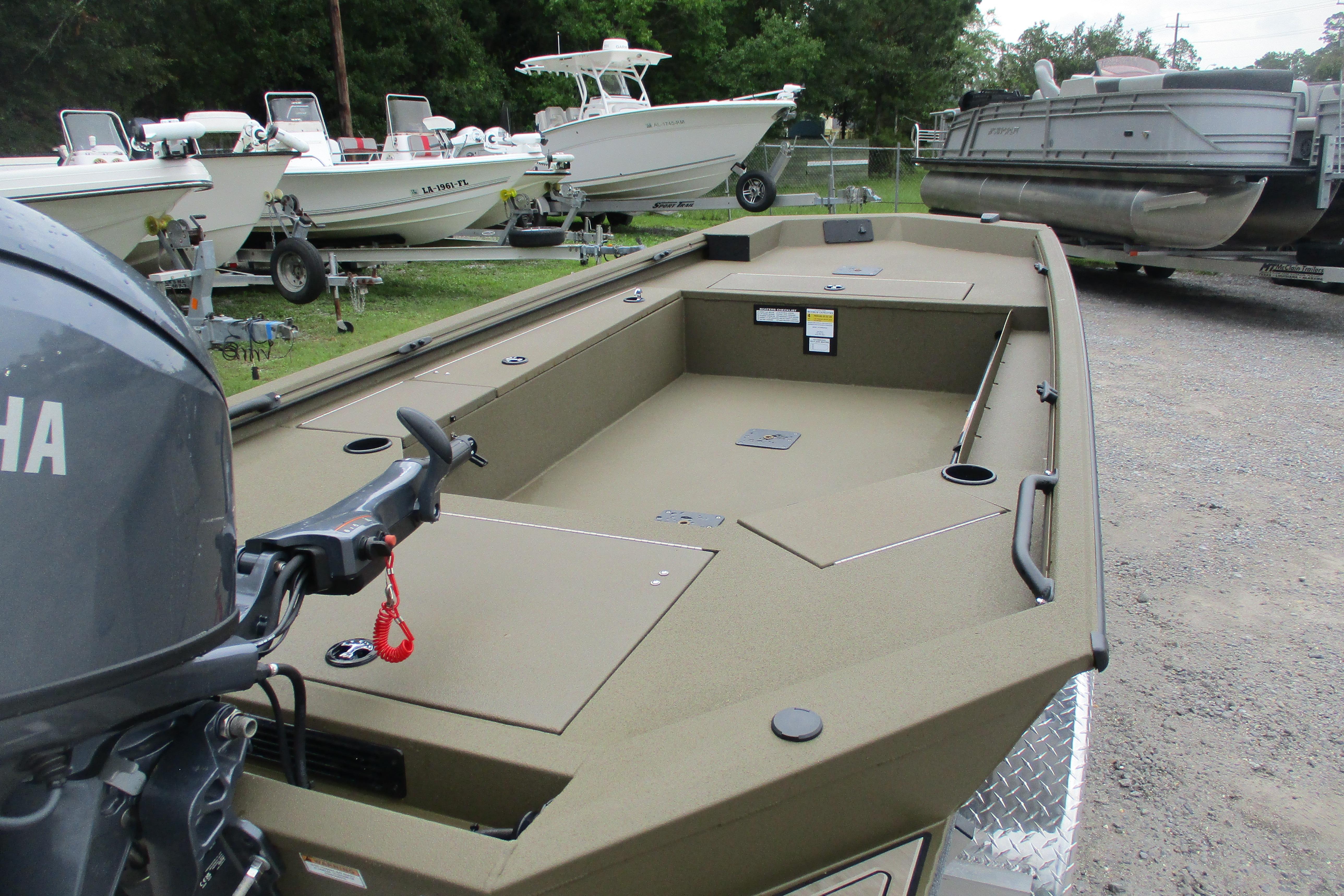2026 Avid 16 Commander boat with Yamaha motor, parked among other boats.