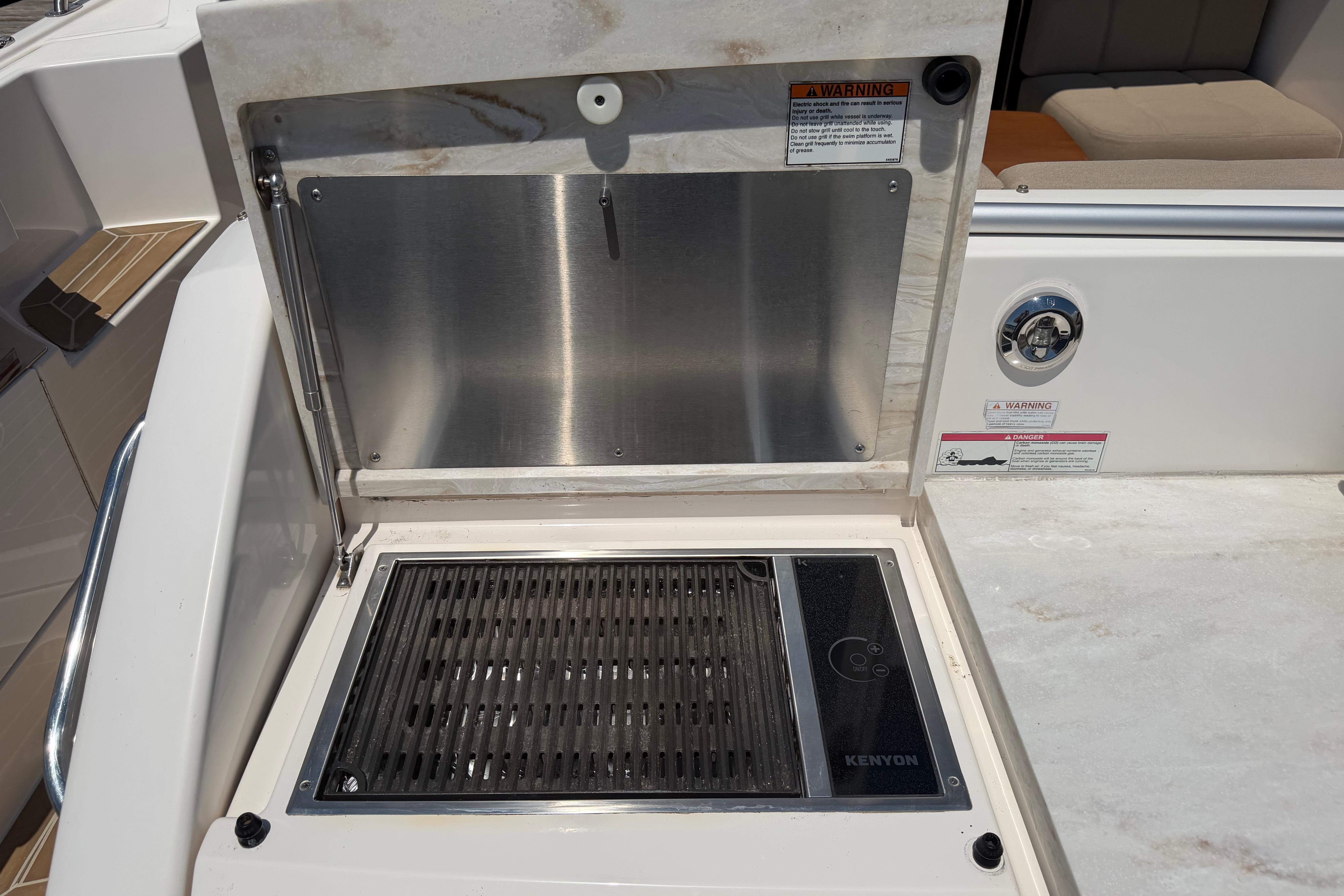 Outdoor grill on 2016 Tiara Yachts C39 Coupe, featuring Kenyon cooking surface.