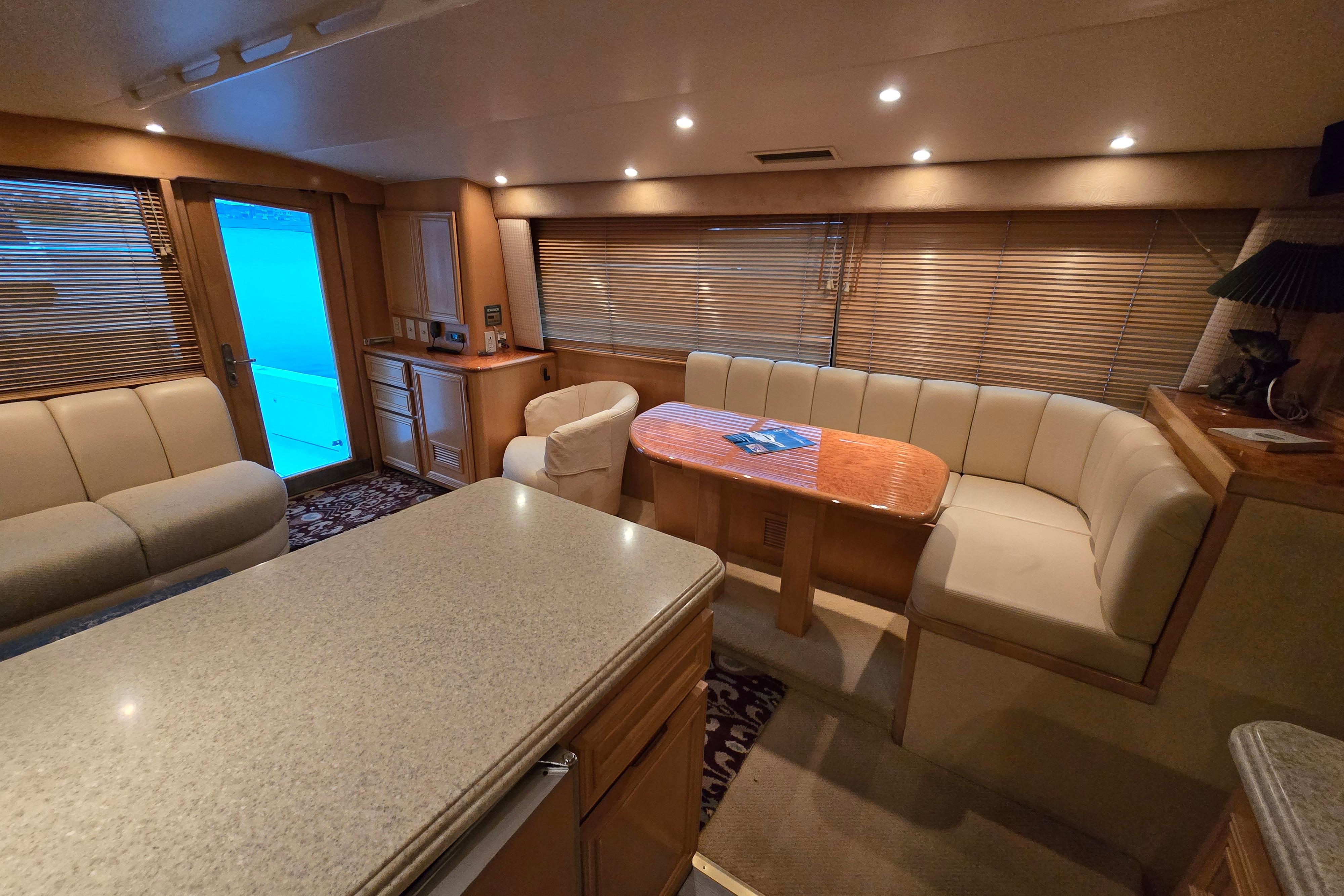 Luxurious interior of a 2001 Cavileer 53 Convertible yacht with elegant seating and ambient lighting.