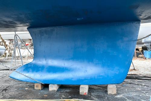 2008 Beneteau Oceanis 46 sailboat keel in dry dock, blue hull.