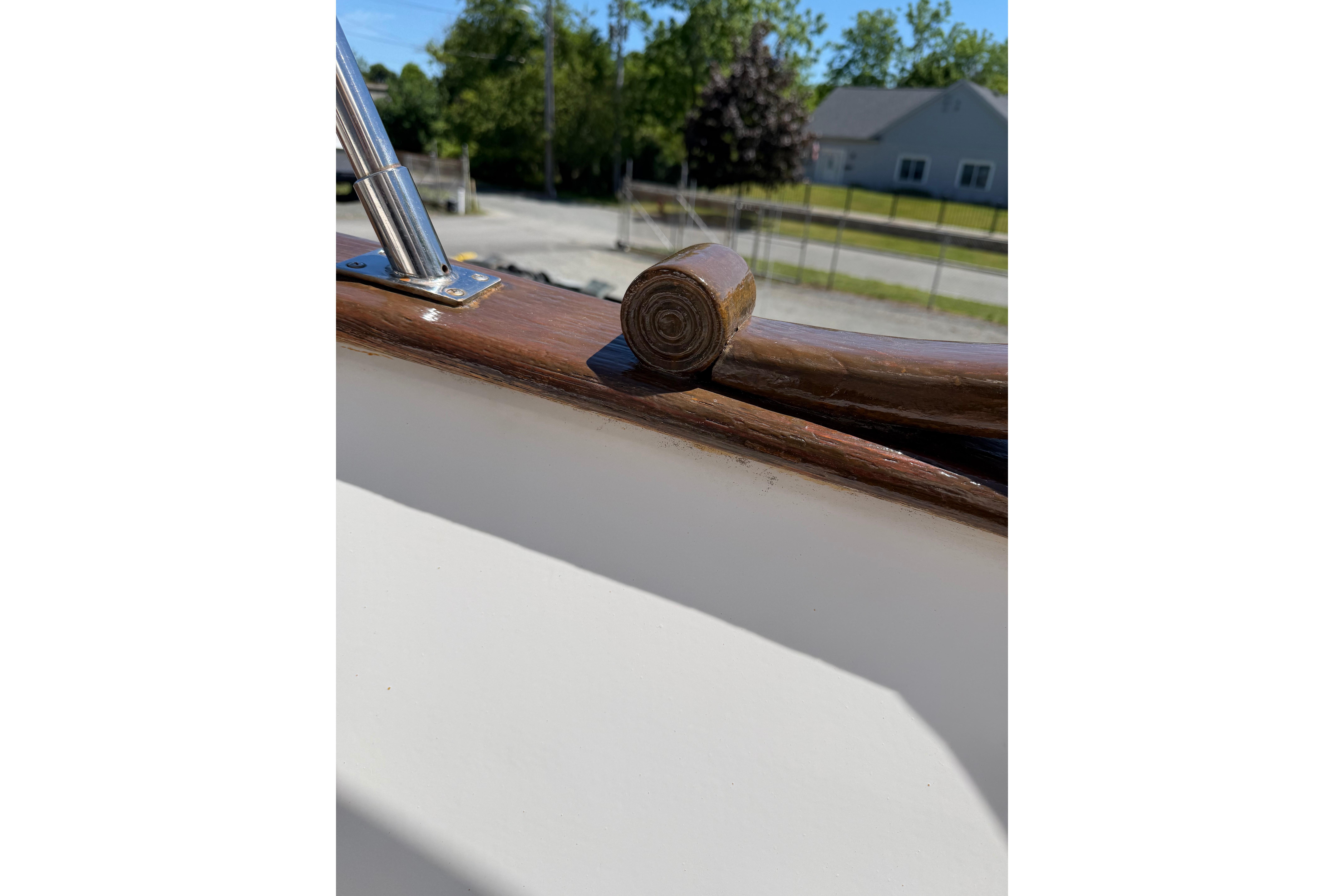 Close-up of 1987 Marine Trader 36 boat's wooden railing detail.