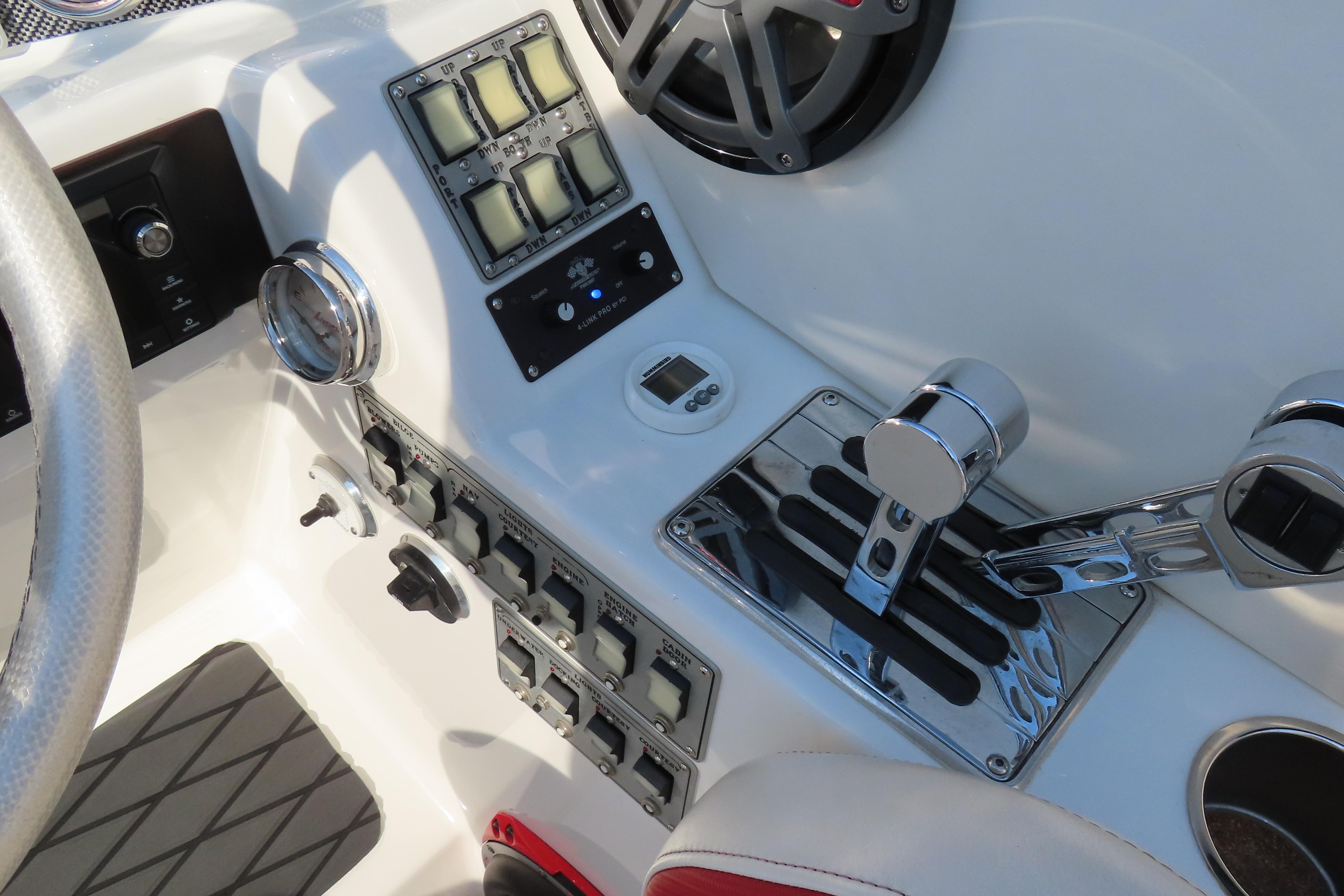 Control panel of a 2013 Nordic 39 POKER RUN boat with switches and throttle levers.