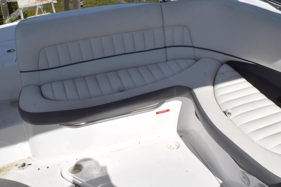 White leather seating on a 2006 Cobalt 240 boat, featuring a sleek, curved design.