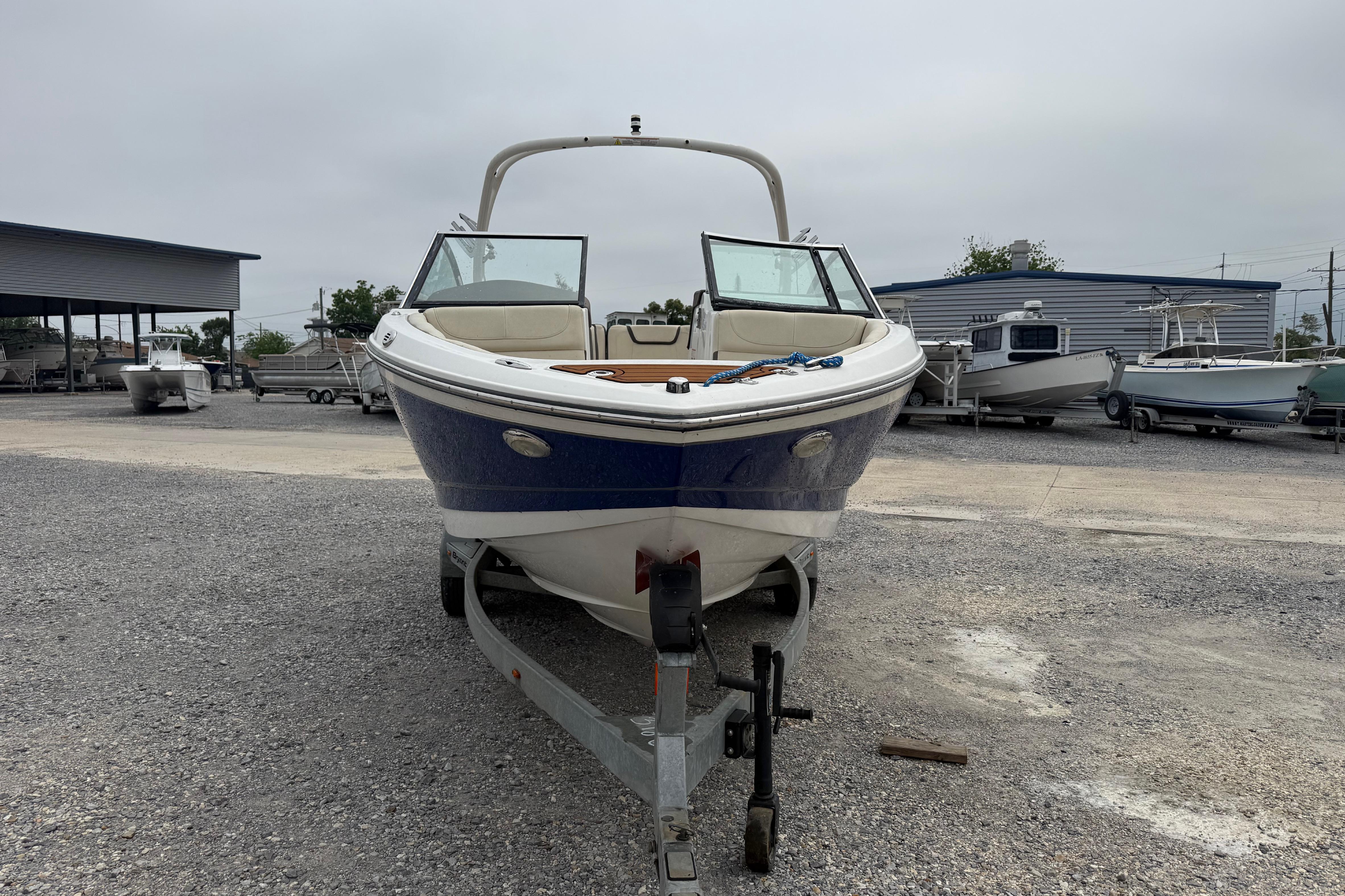 2018 Bryant Calandra boat on trailer in outdoor storage area.