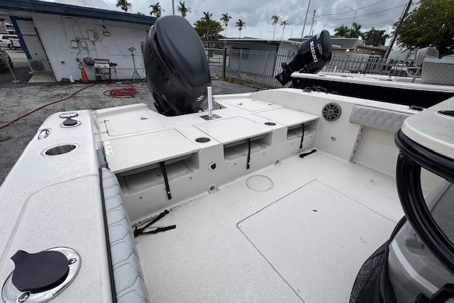 2026 Carolina Skiff 24 Ultra Elite boat interior with storage compartments and motor.