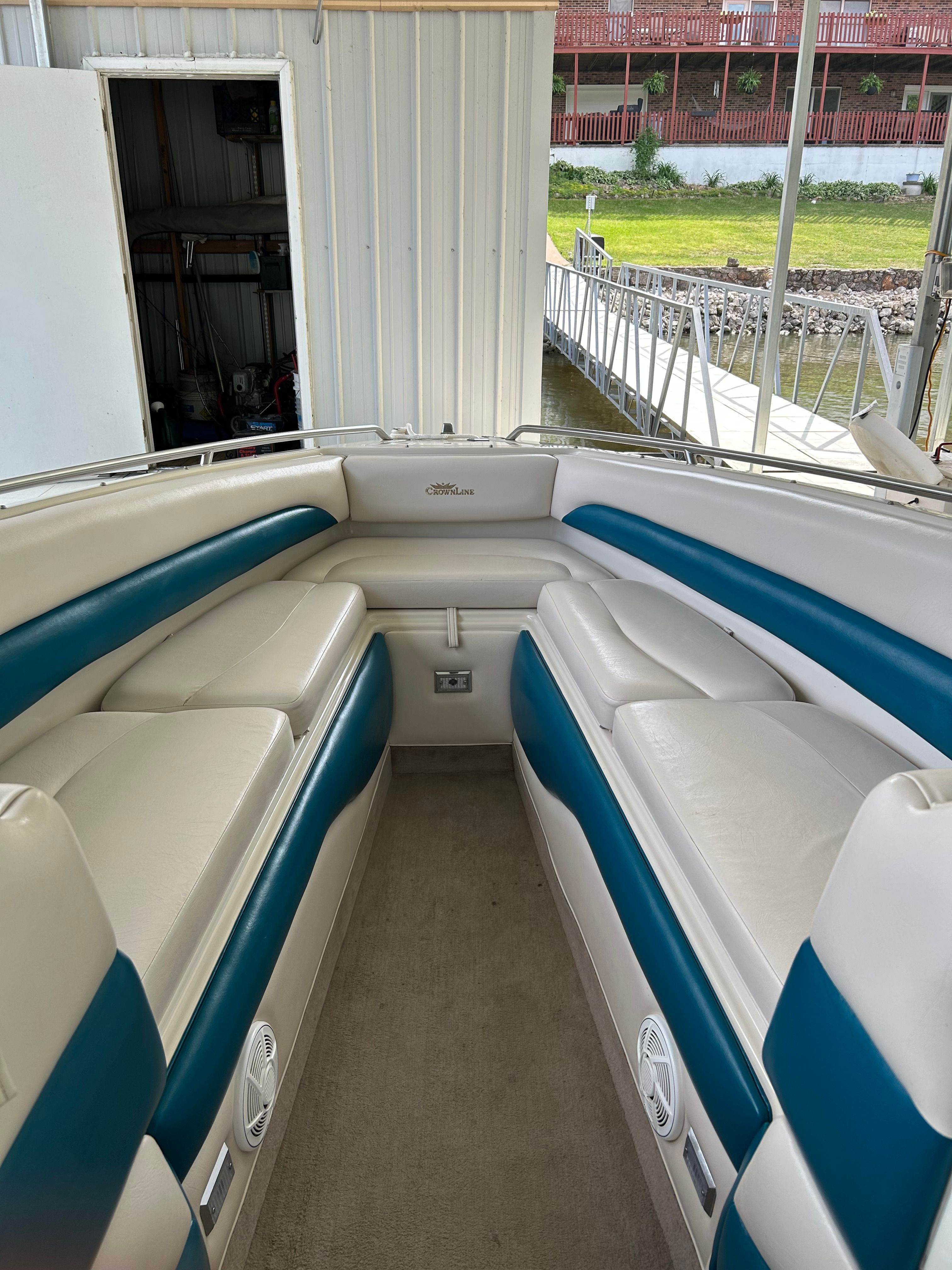 Interior of a 1995 Crownline 266 BR boat with blue and white seating.