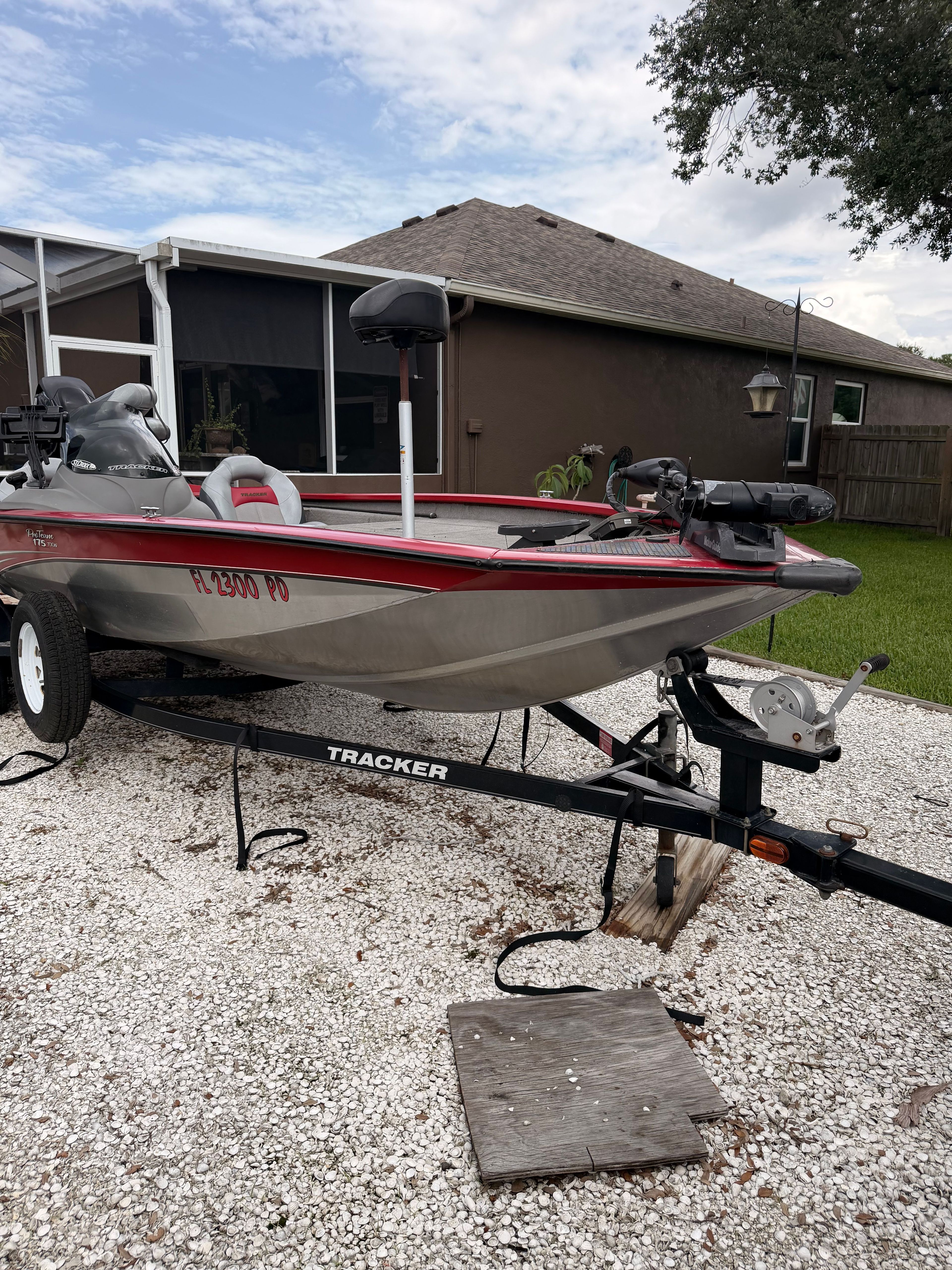 2011 Bass Tracker PRO TEAM 175 TXW on trailer in front of house.