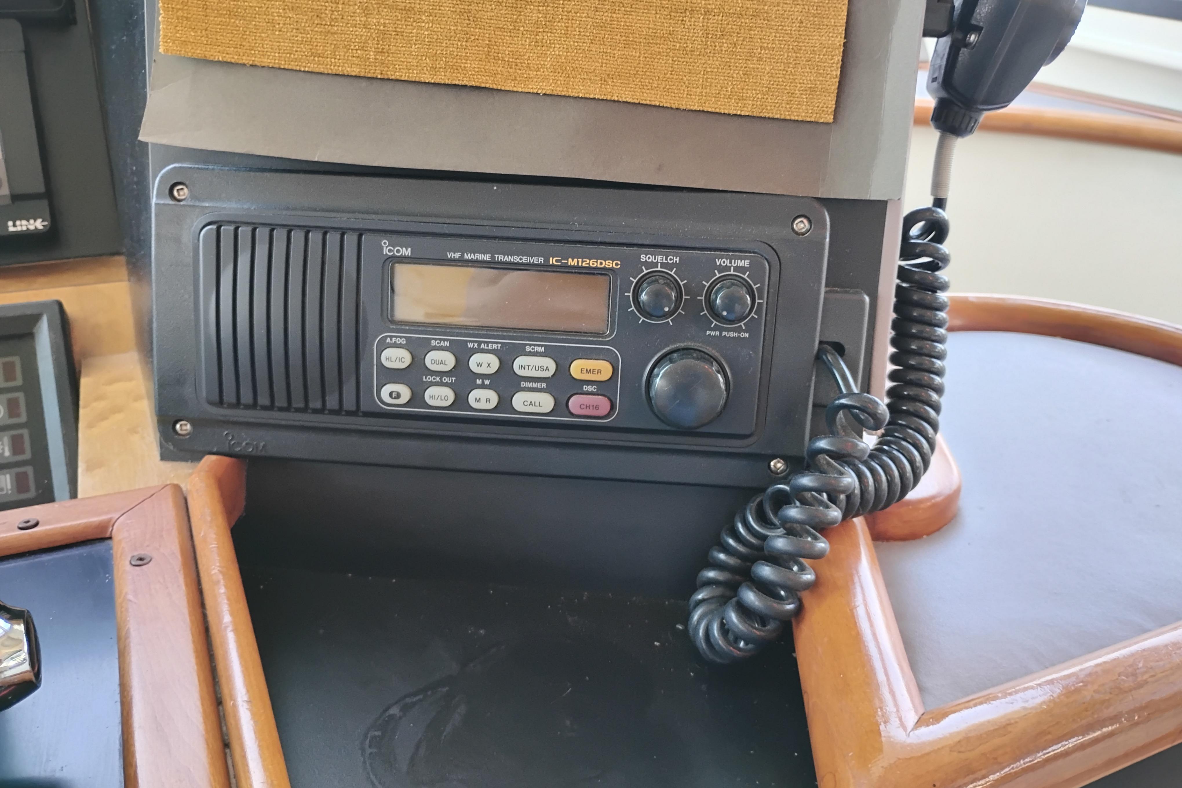 VHF marine transceiver on 1995 Queenship 62 Pilothouse Motor Yacht dashboard.