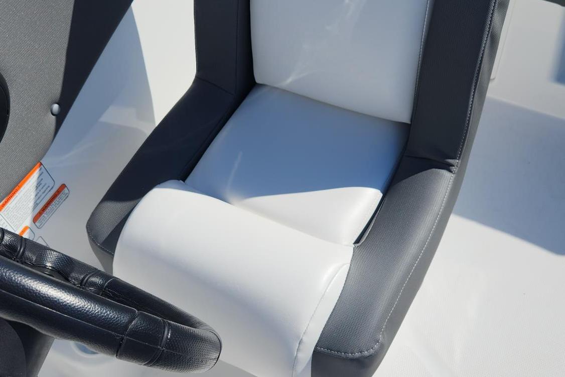 2026 Tahoe T21 boat seat with black and white upholstery, featuring a steering wheel.