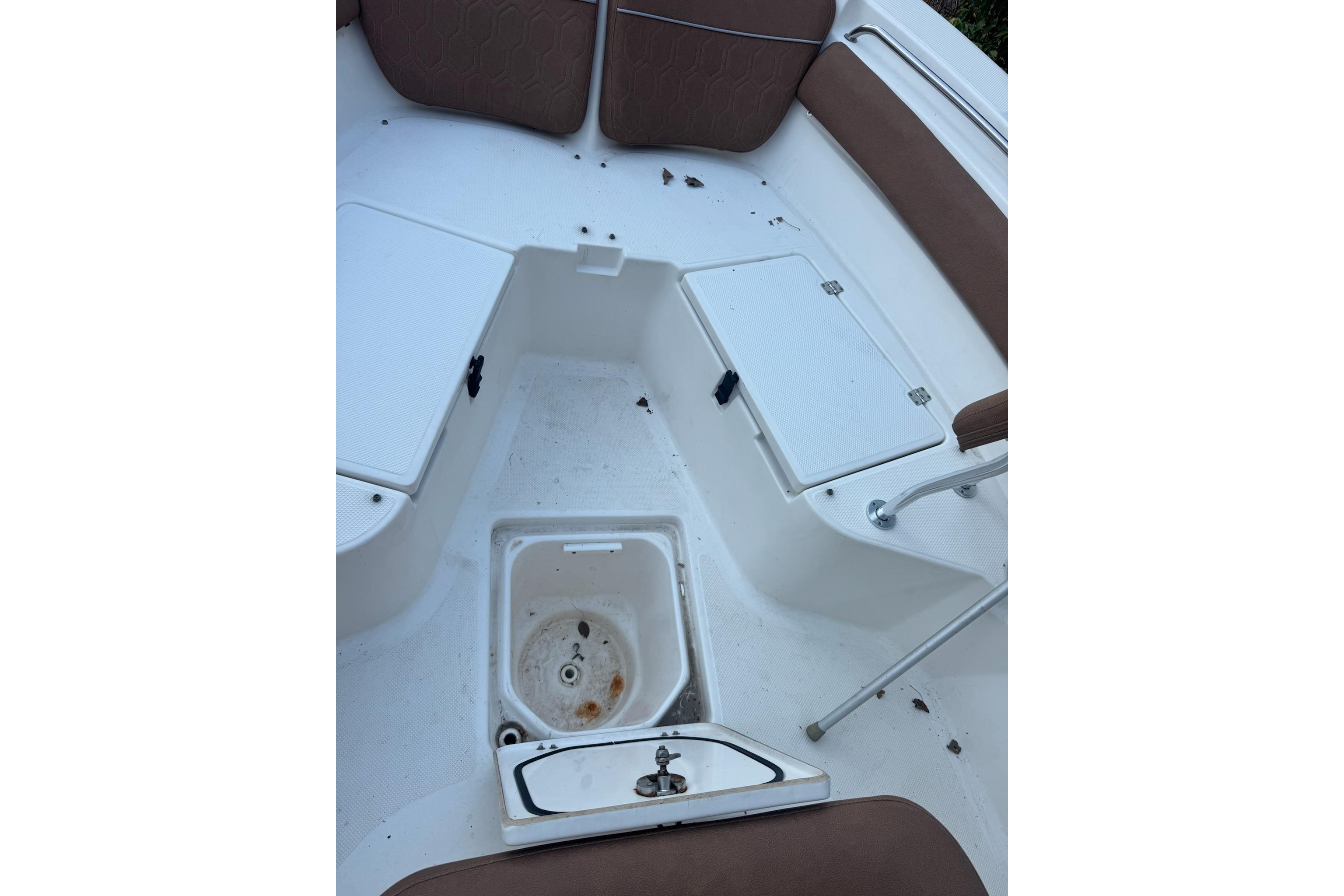2013 Sea Fox 246 Commander boat interior with seating and storage compartments.