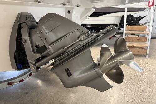 2027 Regal LS4 boat with Volvo Penta outdrive, showcasing dual propellers in a showroom.