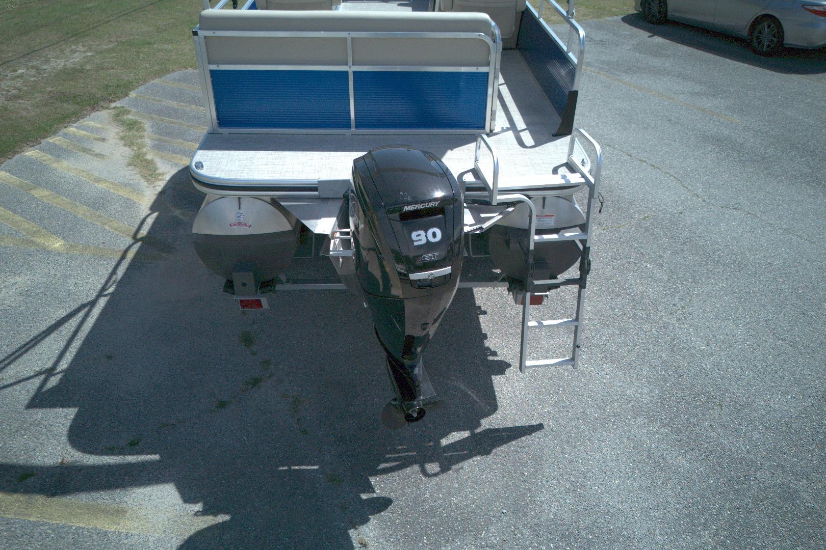 2024 Lowe Ultra 200 Cruise pontoon boat with Mercury 90 engine, parked on pavement.
