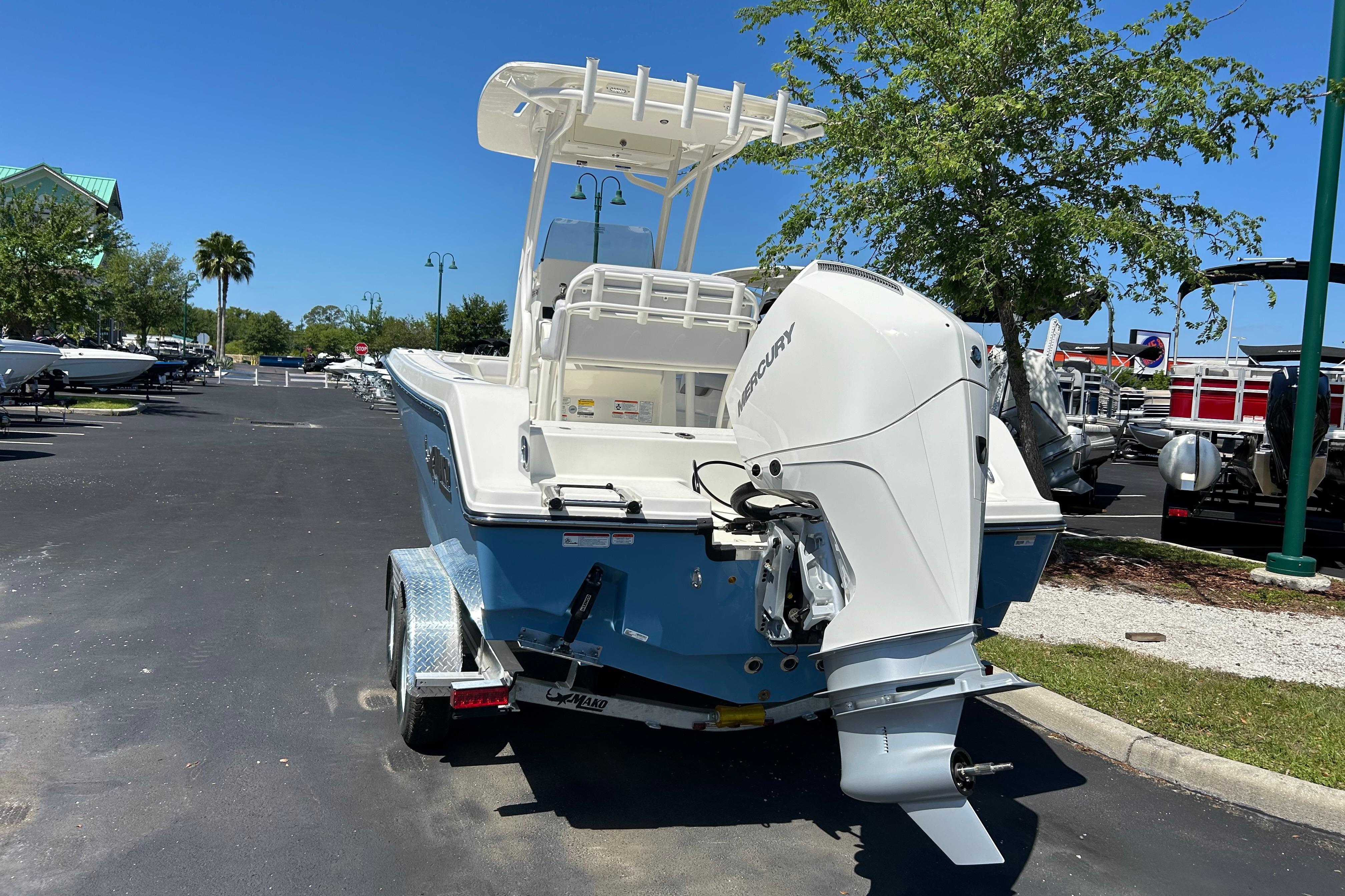 2026 Mako 226 Center Console boat with Mercury outboard engine, parked outdoors.
