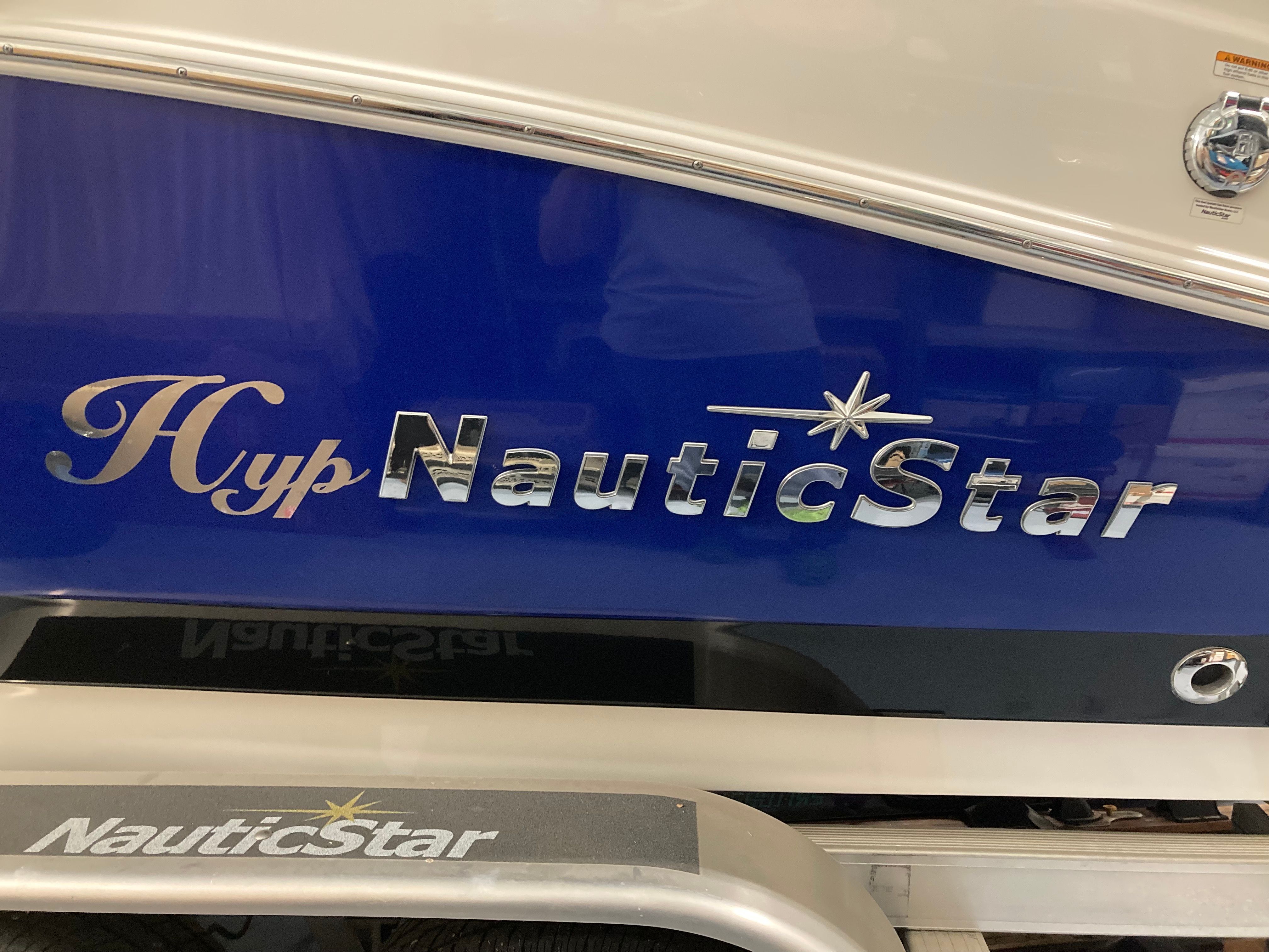 Close-up of the "NauticStar" lettering on a blue boat hull.