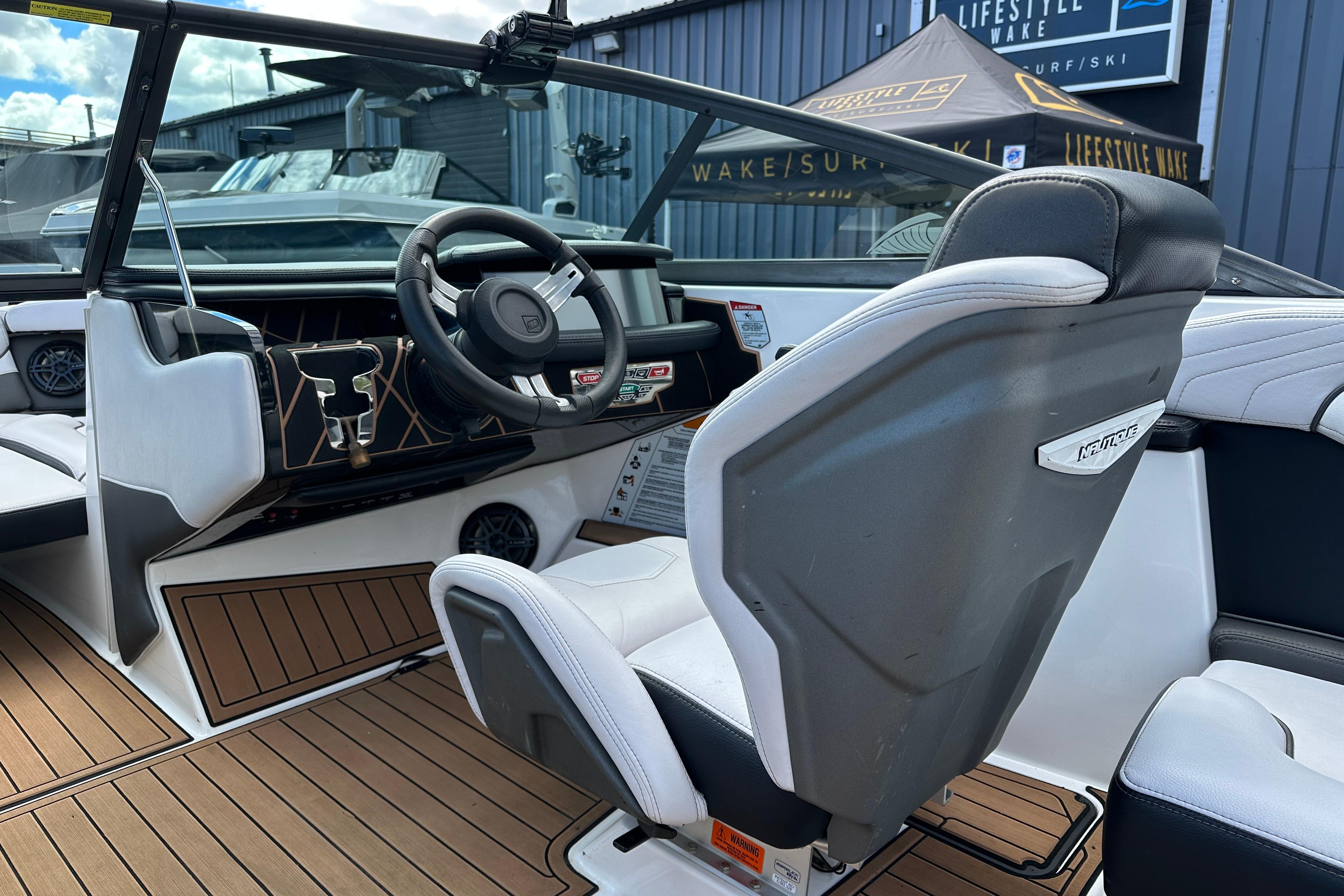 Interior of 2017 Nautique Super Air Nautique GS20 boat with steering wheel and seating.